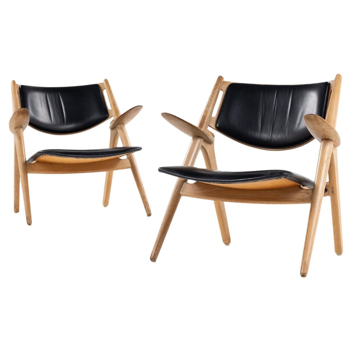 Pair of CH 28 Sawbuck easychairs by Hans J. Wegner. For Sale