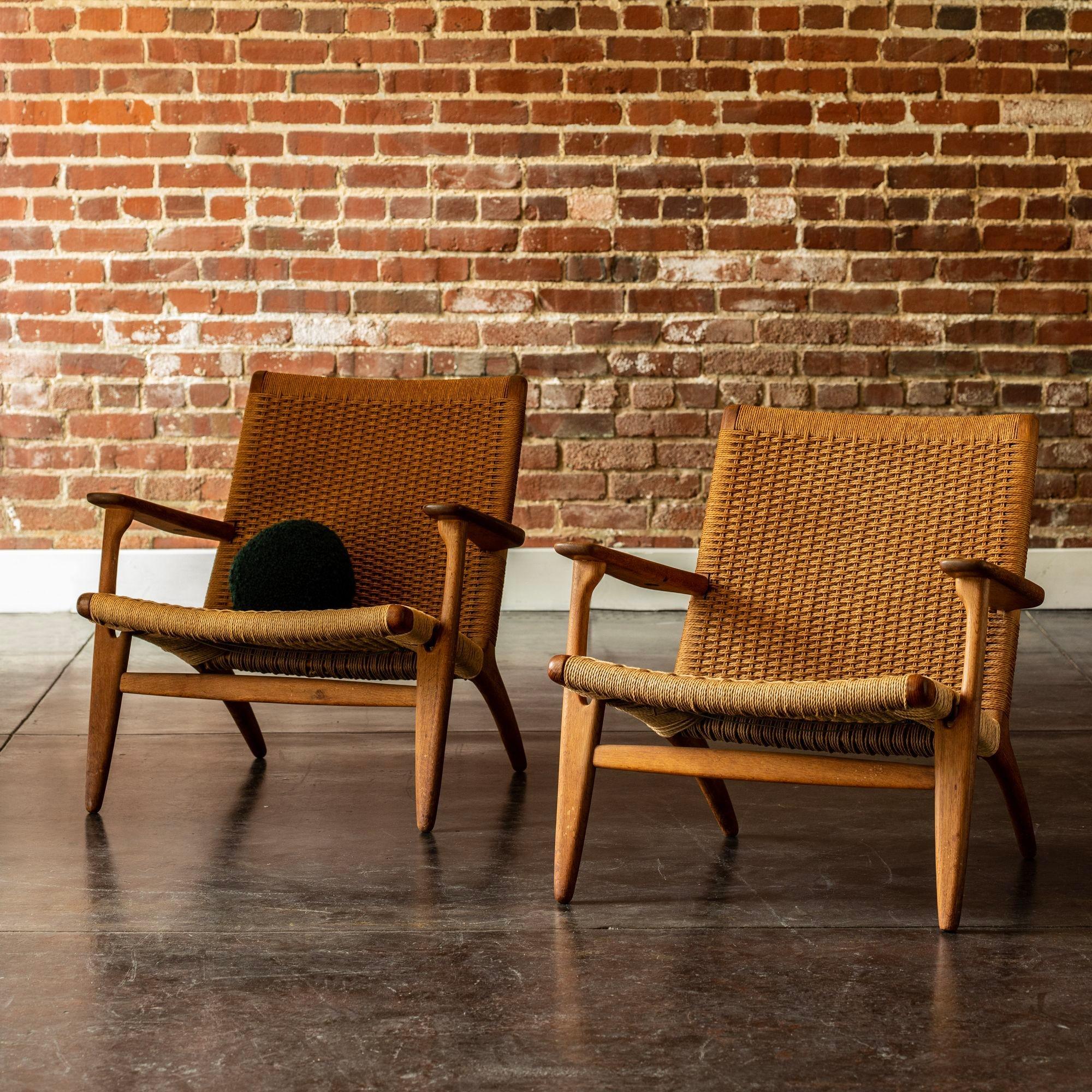 A lovely pair of iconic lounge chairs by Hans Wegner. The CH25 is a classic form executed in oak and paper cord by Carl Hansen & Son. In excellent vintage condition with Danish Control stamp.
 
h 29 in x w 27 in x d 28 in
Seat height 14 in.
