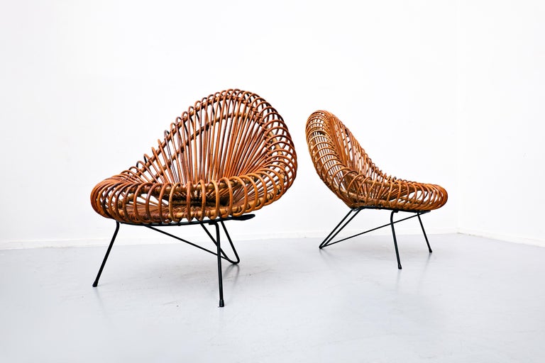 Pair of Mid-Century Modern chairs by Janine Abraham & Dirk Jan Rol for Rougier, 1950s. 
This Iconic Pair of Rattan Armchairs by a couple : Janine Abraham and Dirk Jan Rol. 
Janine Abraham, French designer, studied at École Camondo in Paris. She