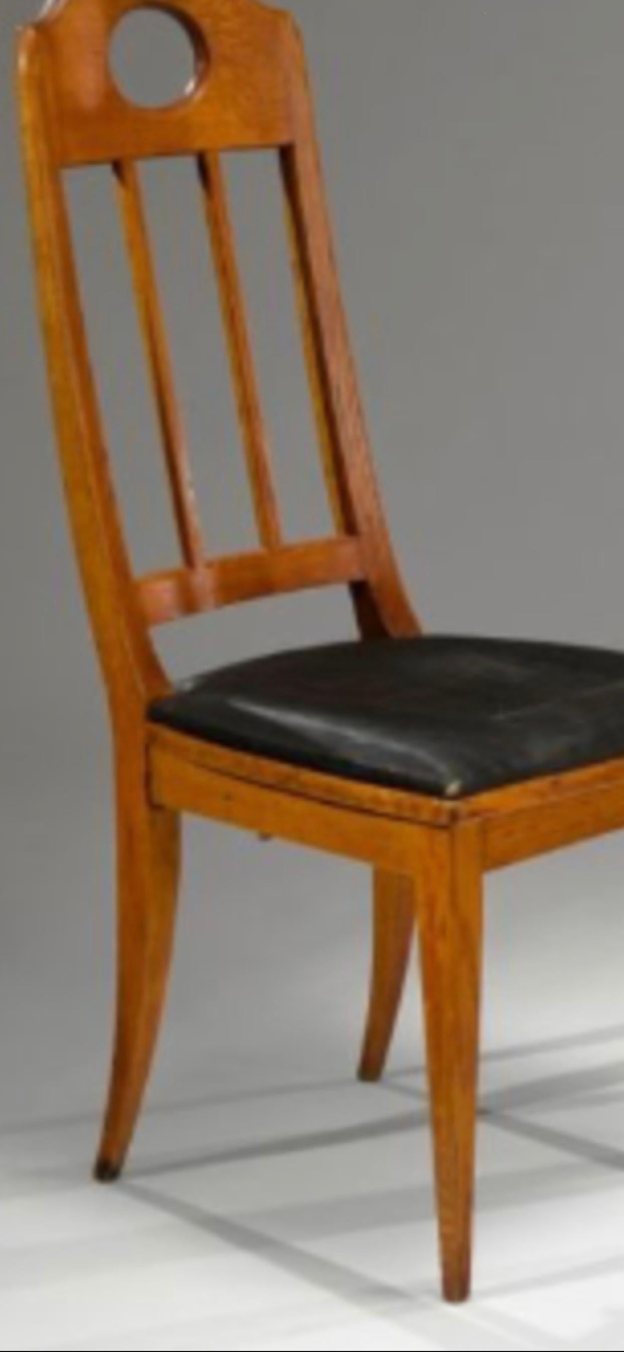 A pair of high back oak chairs, circa 1905.