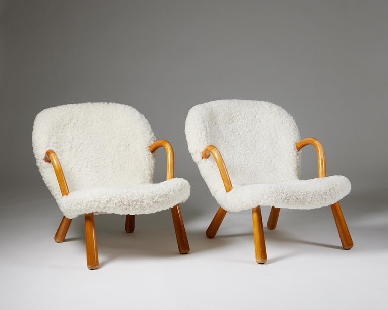 Pair of chairs ‘Clam’ designed by Arnold Madsen for Madsen & Schubell,
Denmark. 1944.
Birch and sheepskin upholstery.

A design with a rather perplexing, yet fascinating history, it has been attributed to several designers before, the latest