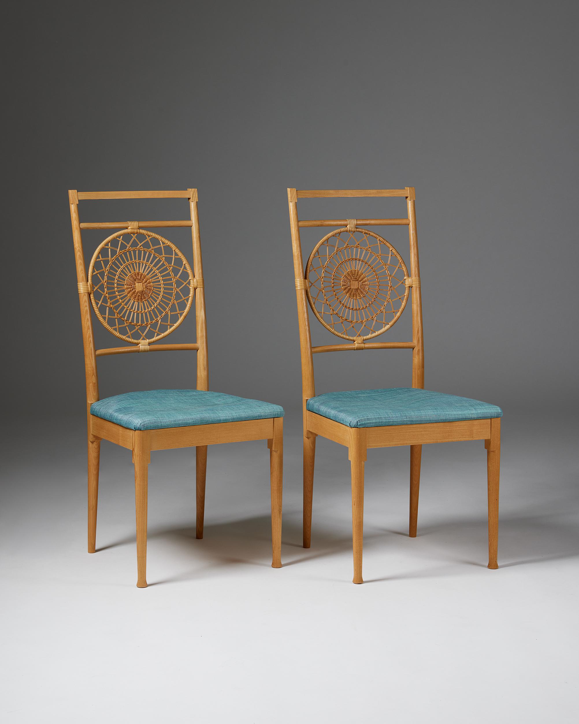 Pair of chairs designed by Carin Chambert and Sigbritt Larsson for Torsten Schollin,
Sweden. 1960s.
Elm, rattan and upholstery.

Stamped.

The model won first prize in the Crafts, Furniture Industry Association, SAR, SIR and Swedish Handicraft