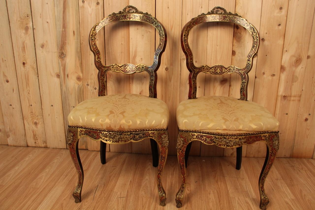 pair of flying chairs from the Napoleon III period, 19th century, in Boulle marquetry and blackened wood decorated with gilded bronzes in good condition