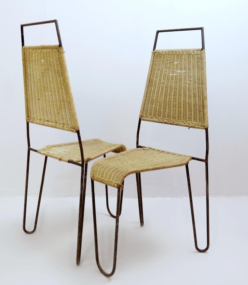 pair of chairs in wicker and steel attr. to Raoul Guys for Airborne , ca 1950.