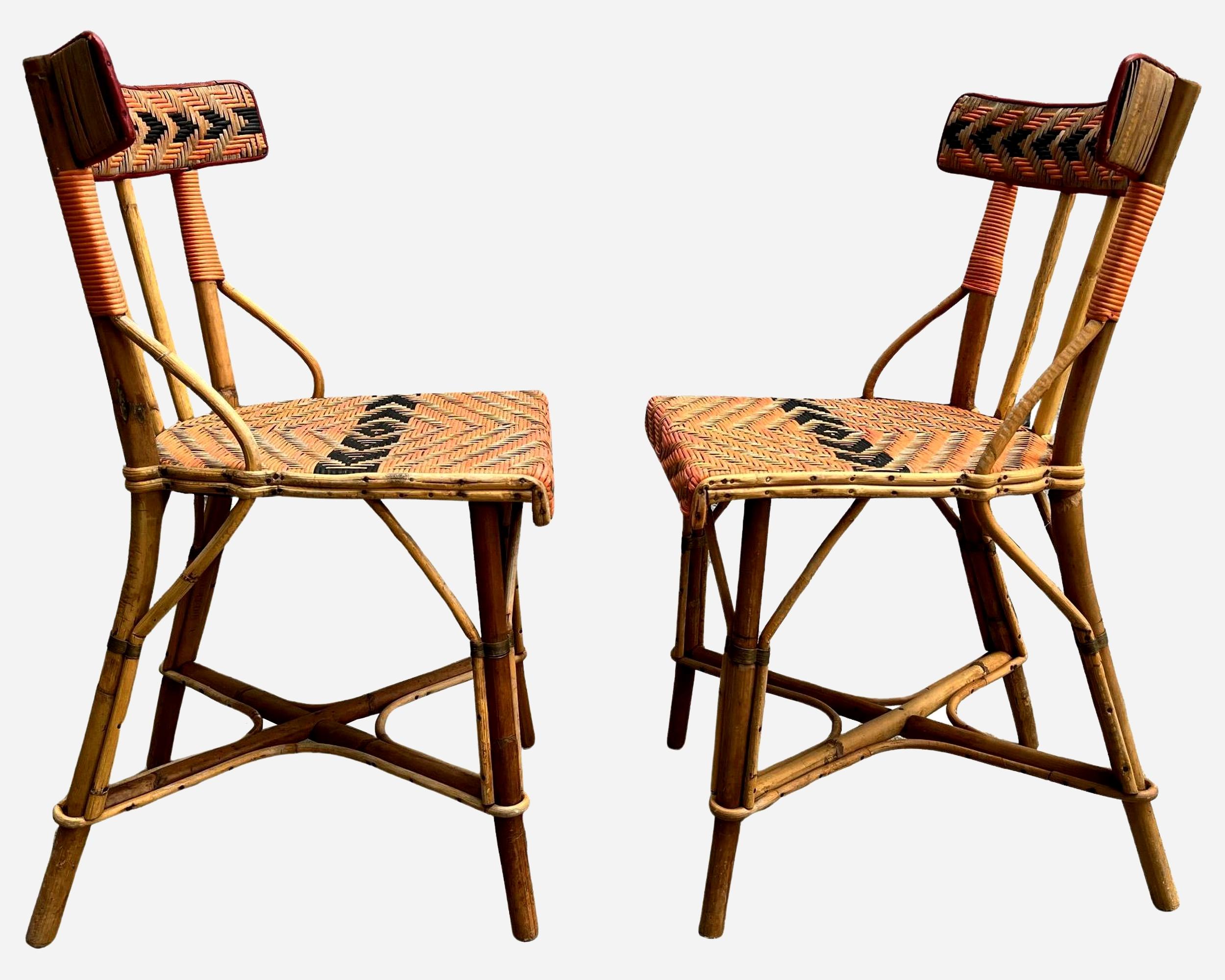 Attractive pair of chairs in natural, red and black woven  rattan . Bamboo structure.