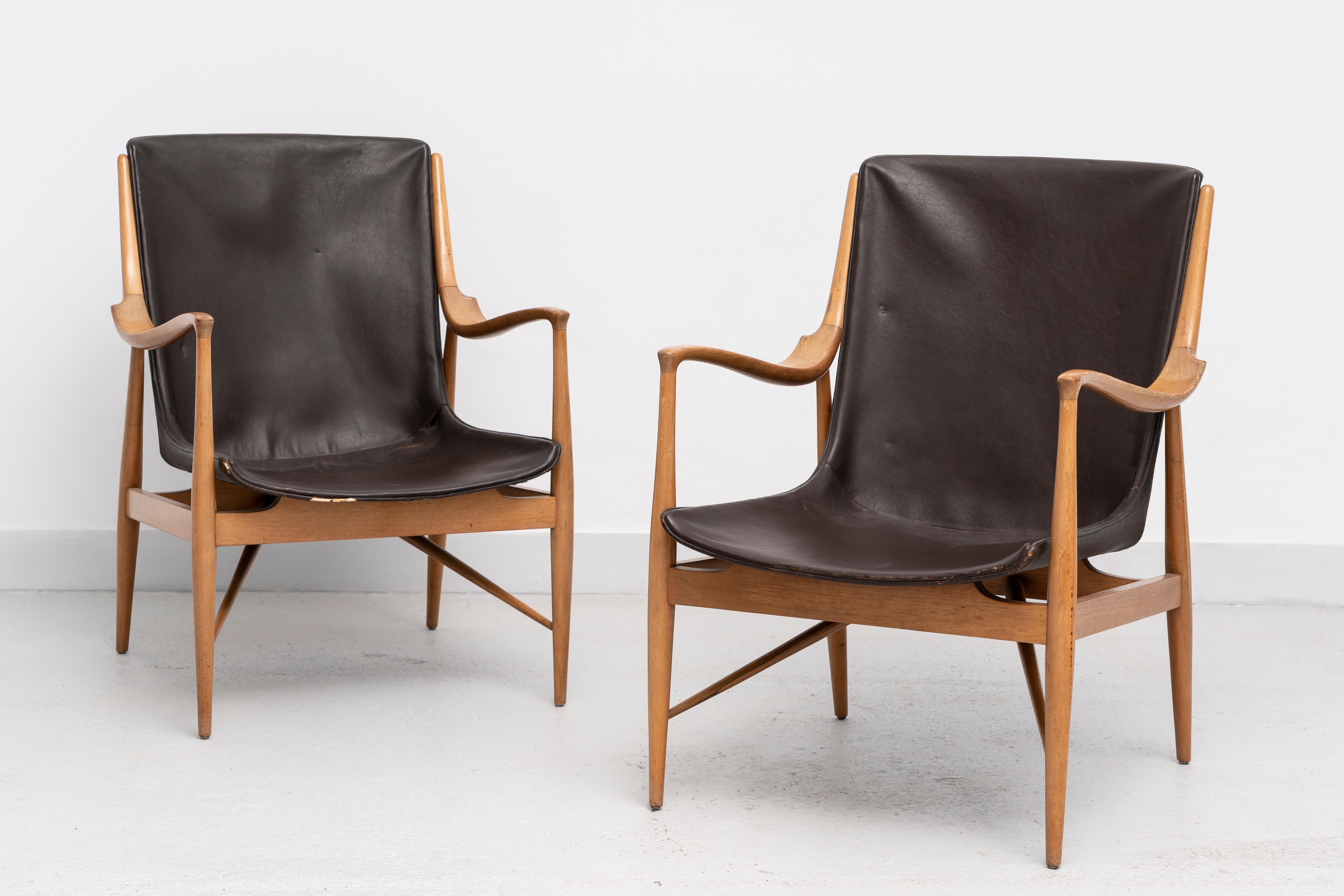Designed in 1945, this pair of teak wood chairs with black leather upholstery were produced at a later time than the original design between 1960 and 1969. The House of Finn Julh defines this model as follows “In the fall of 1945, Finn Juhl