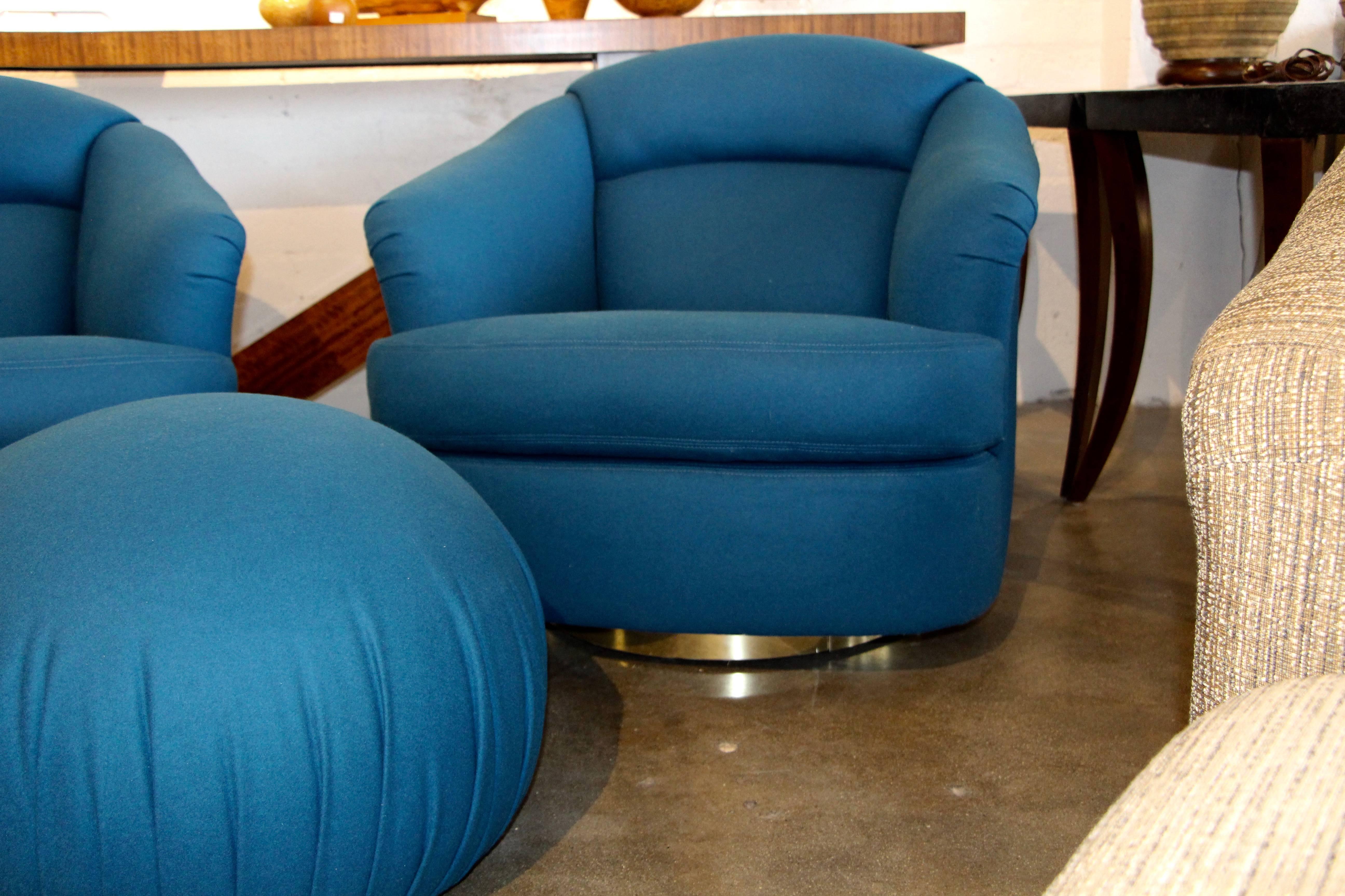 Directional set of two chairs and an ottoman in a new peacock blue wool fabric. Chairs swivel and lean back. On chrome or stainless wrapped bases. The ottoman is not. This set has been re-upholstered and there are some minor marks to the metal