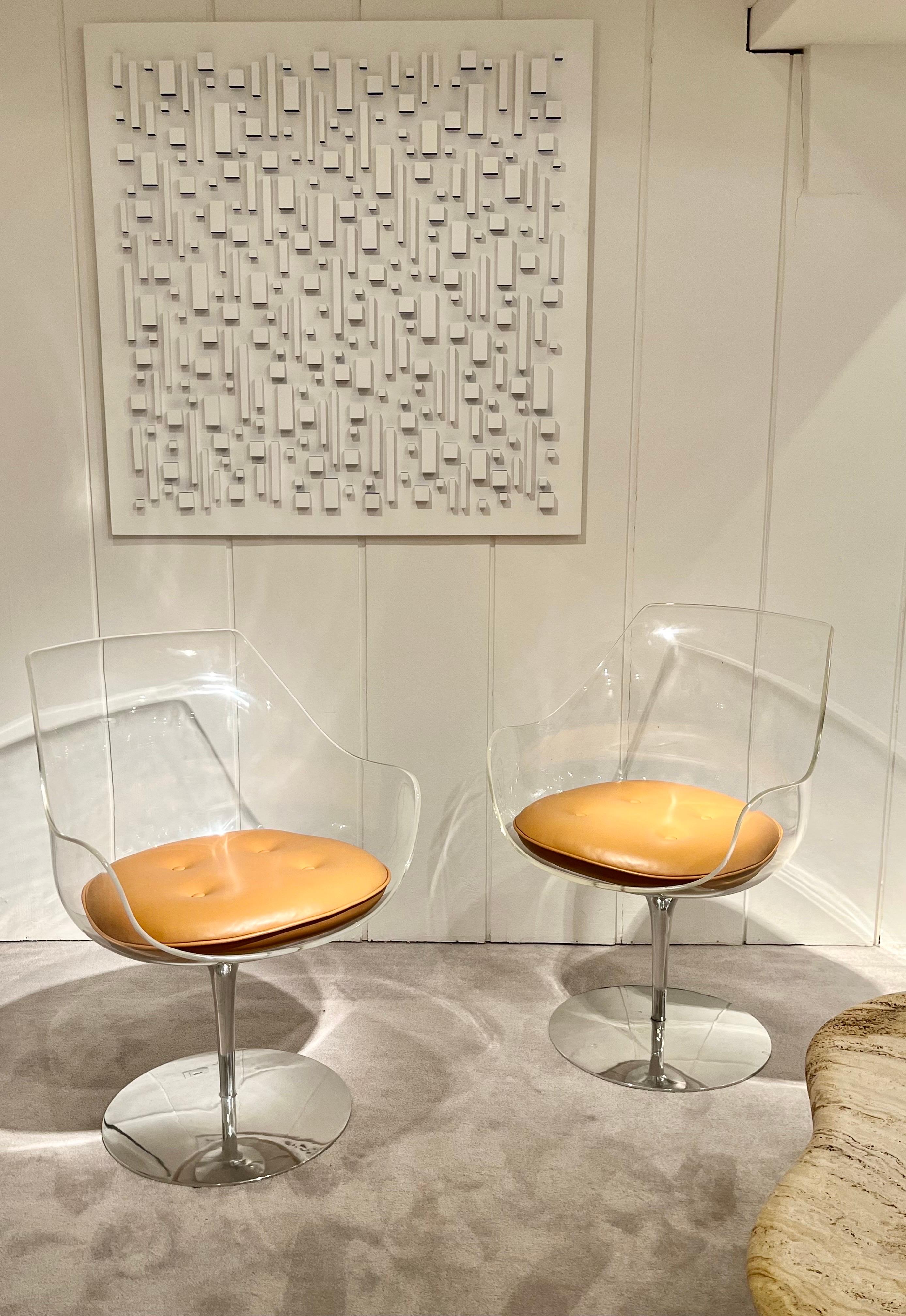 Pair of Lucite chairs By Erwine & Estelle Laverne,
Edited By Formes Nouvelles
Lucite and polished aluminum Champagne swivel chair. 
New havana leather cushions. 
 Signed and stamped on bottom: Laverne.