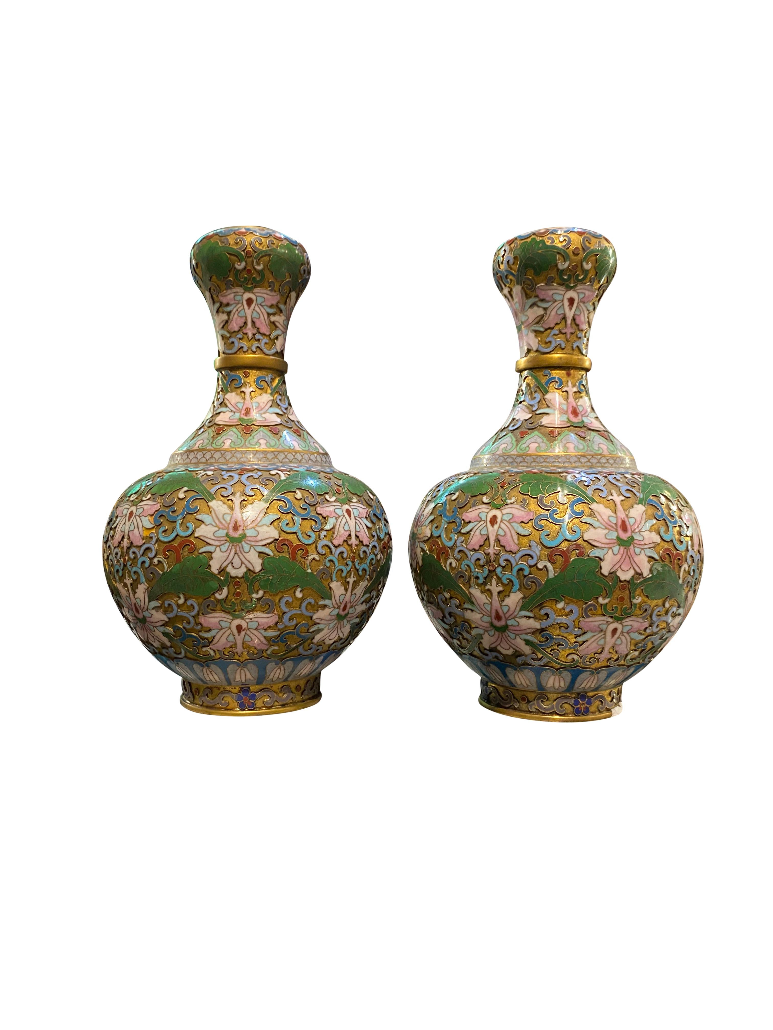 Pair of champleve cloisonne antique vases green and pink flowers blue red white, 19th century. Stunning floral decoration and vibrant colors. Perfect for home interior.
