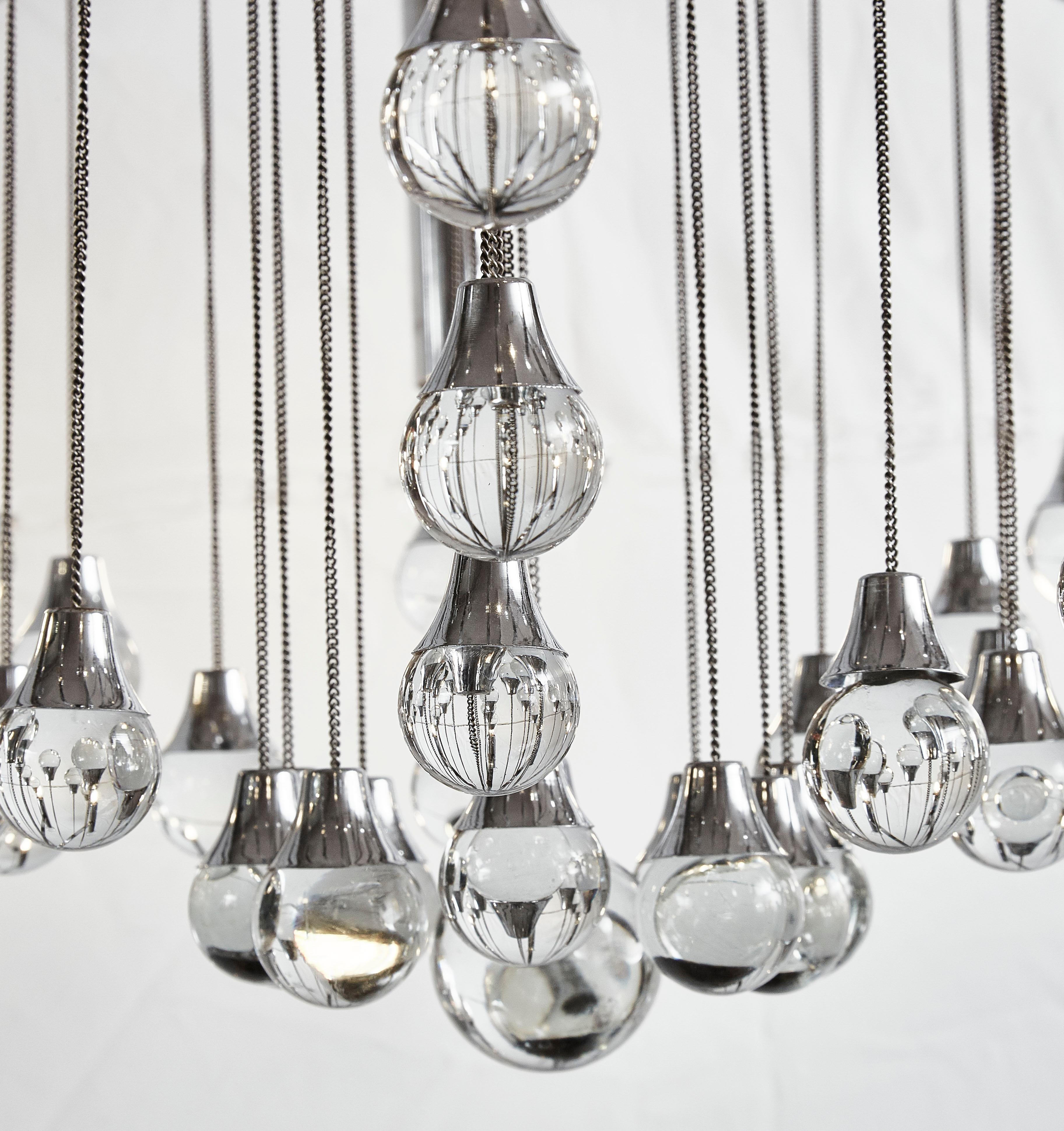 Pair of steel and Murano glass chandeliers designed by Gaetano Sciolari (1927-1994).