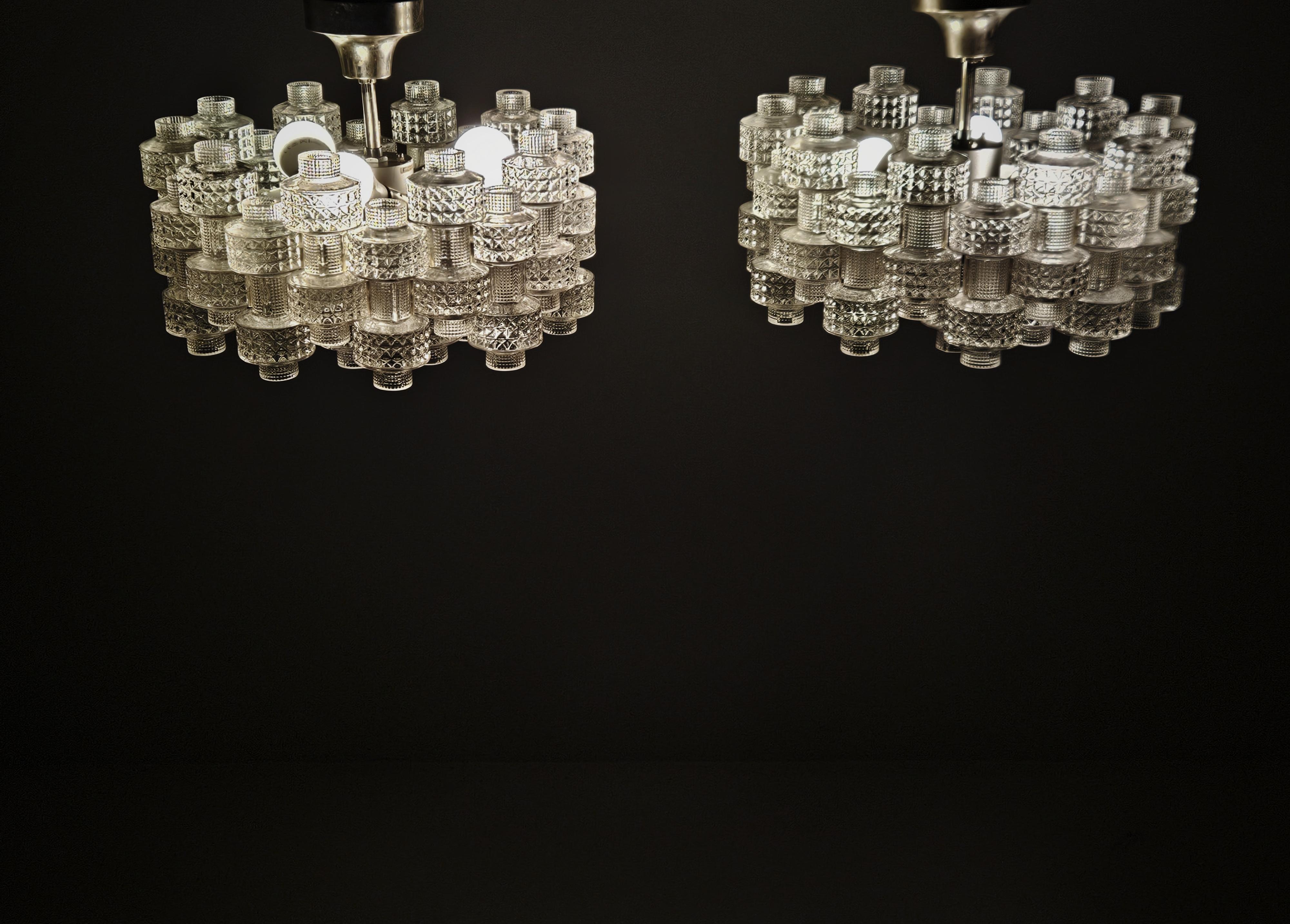 Great rare pair of chandeliers designed by Gert Nyström for Fagerhult, Sweden, during the 1970s. 

Made with besutiful glass made by Orrefors mounted on a steel frame. 