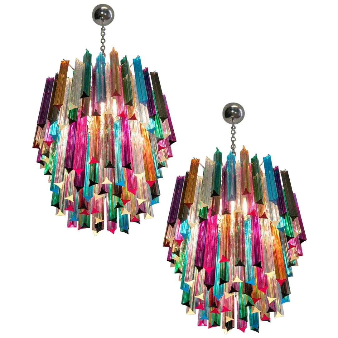 Fantastic pair of Murano chandeliers made by 107 Murano crystal multicolored prism in a nickel metal frame. The glasses are transparent, blue, smoky, purple, green, yellow and pink.
Dimensions: 55.10 inches height (140cm) with chain, 29.50 inches