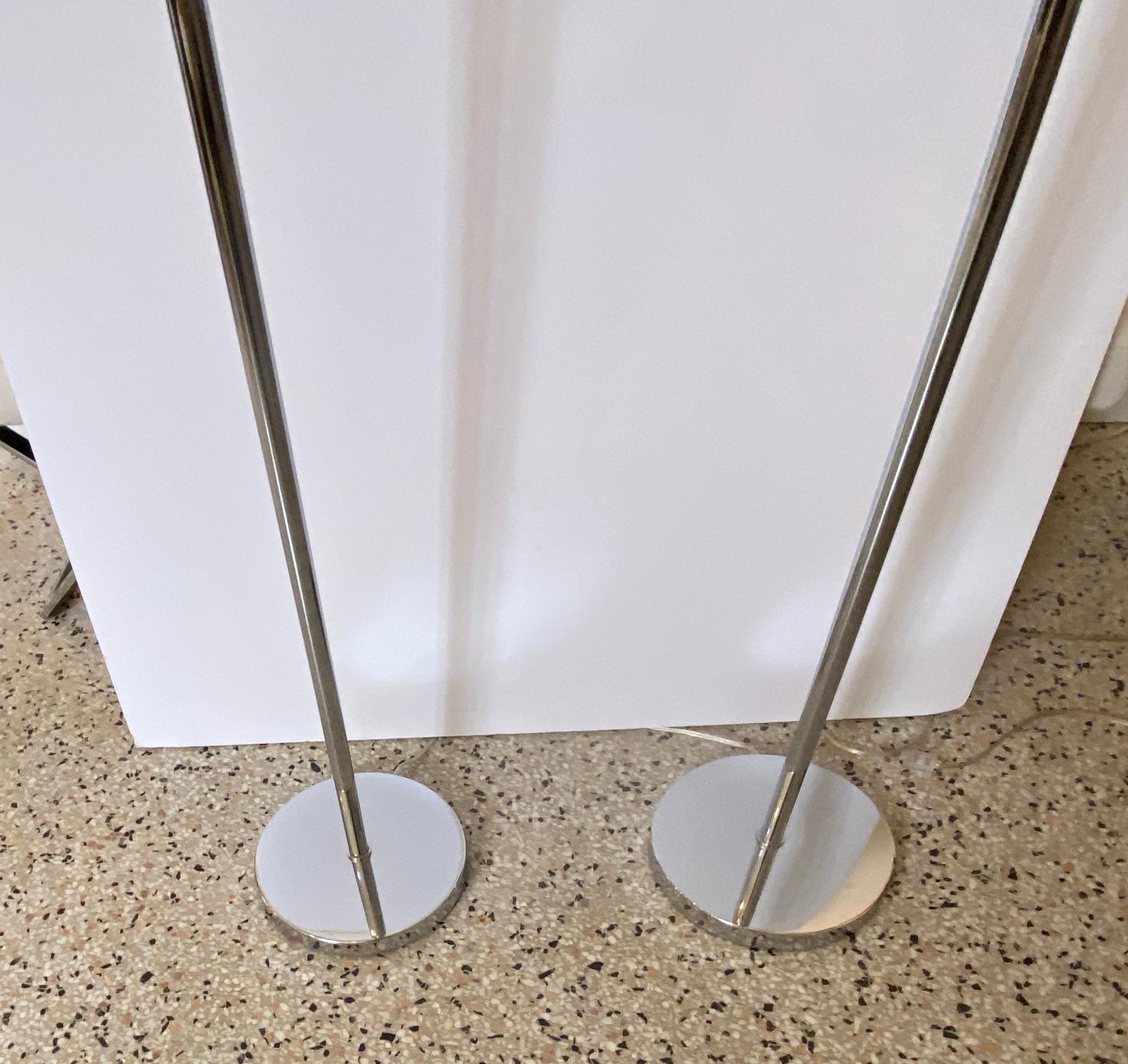This stylish and classic set of Hansen floor lamps date to the 1970s and they are a married set that were made at different productions times.

Note: The shades are new and they are a white linen textures on a hard back.

Note: The lamps finials