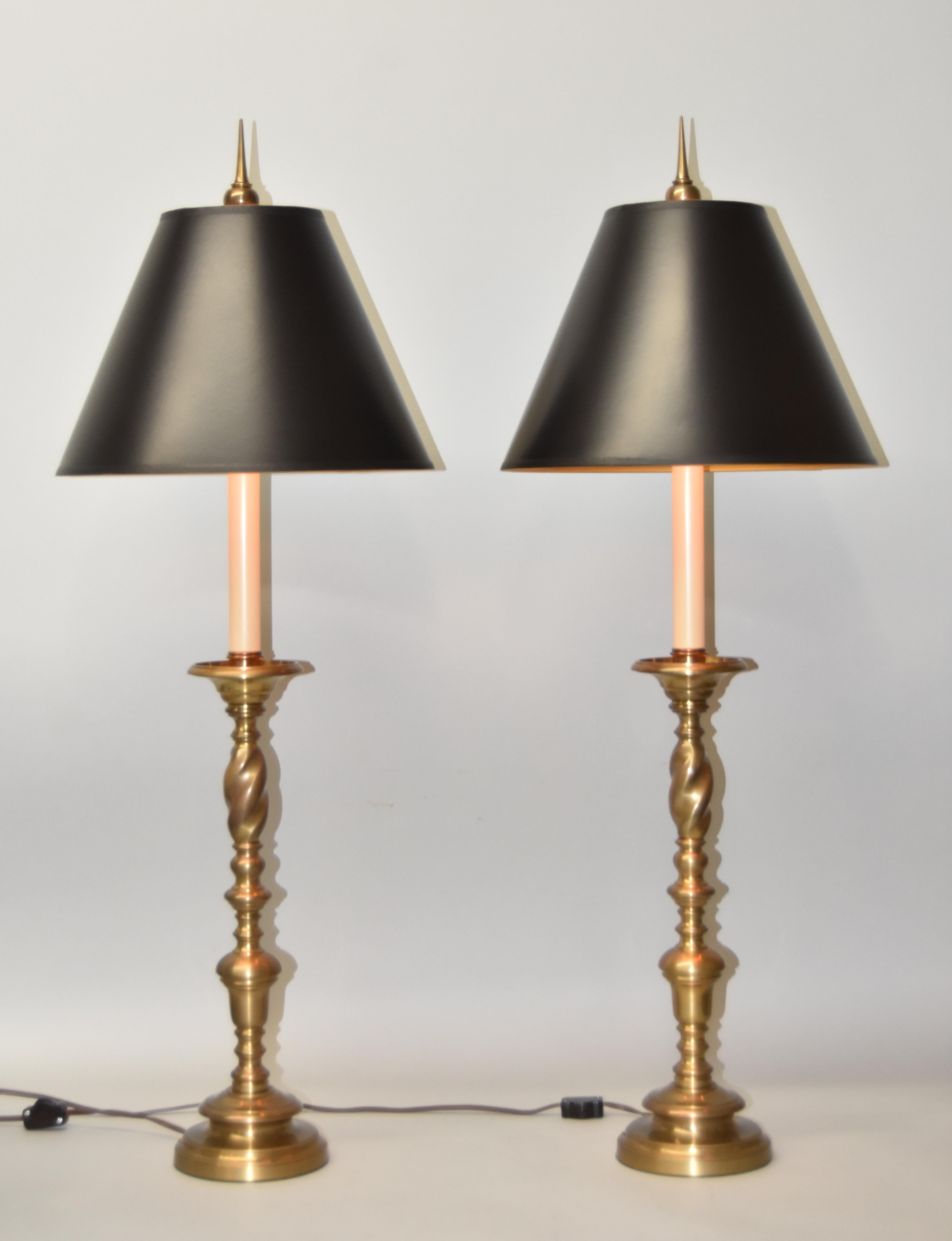 Pair of brass Chapman table lamps with a two way original single sockets. Nice patina. Tall tip finial.
