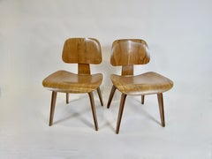 Pair of Charles and Ray Eames Herman Miller Calico Ash DCW chairs