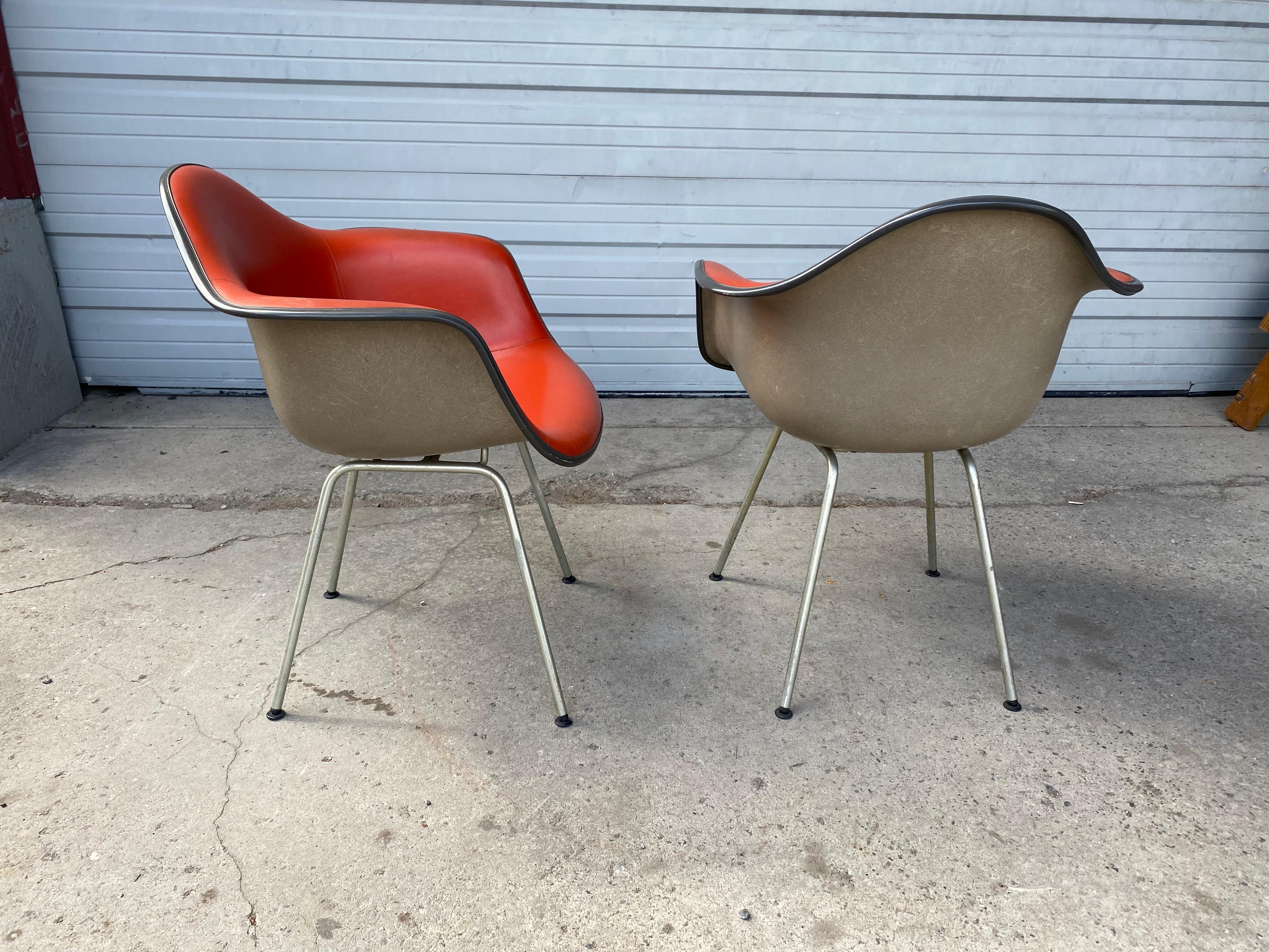 Classic pair of Mid-Century Modern padded arm shell chairs,Designed by Charles and Ray Eames, for Herman Miller. Beautiful two-tone, chairs are in really nice original condition. Extremely comfortable. Retain all 8 feet glides...