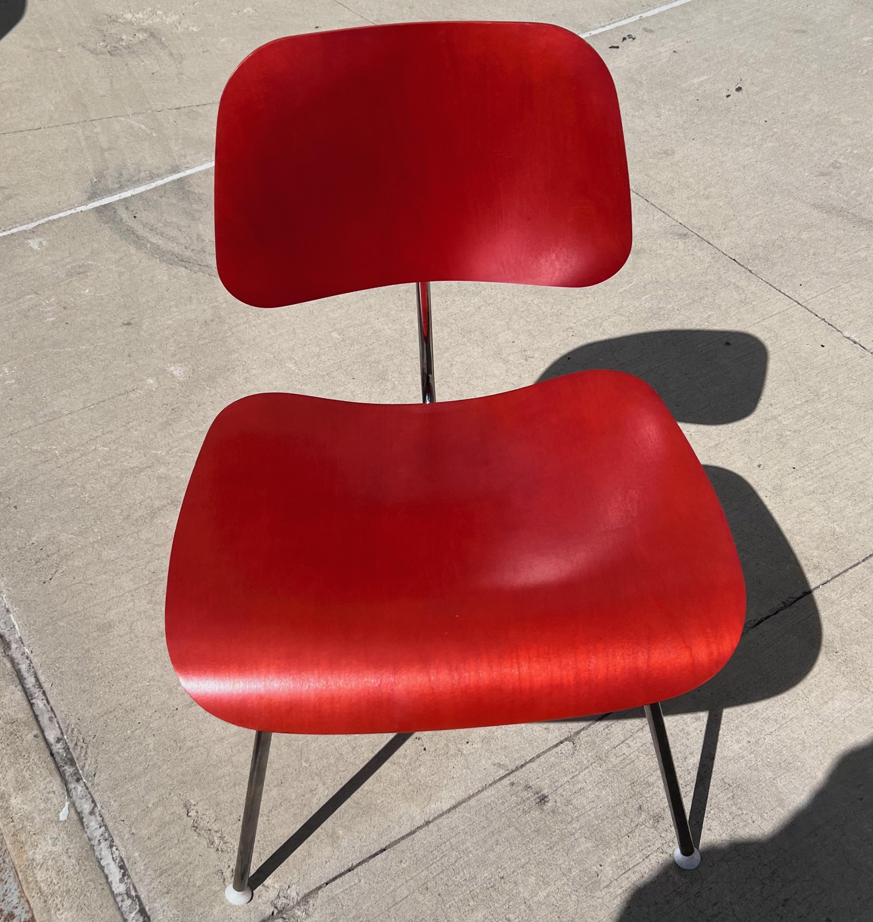 Charles and Ray Eames red beech DCM chair, Herman Miller, dining, side chair. Labeled. Designed in 1946. Produced in 2017.

Authentic Eames chair for everywhere - a lovely complement to any dining room table or office, this chair’s curved plywood