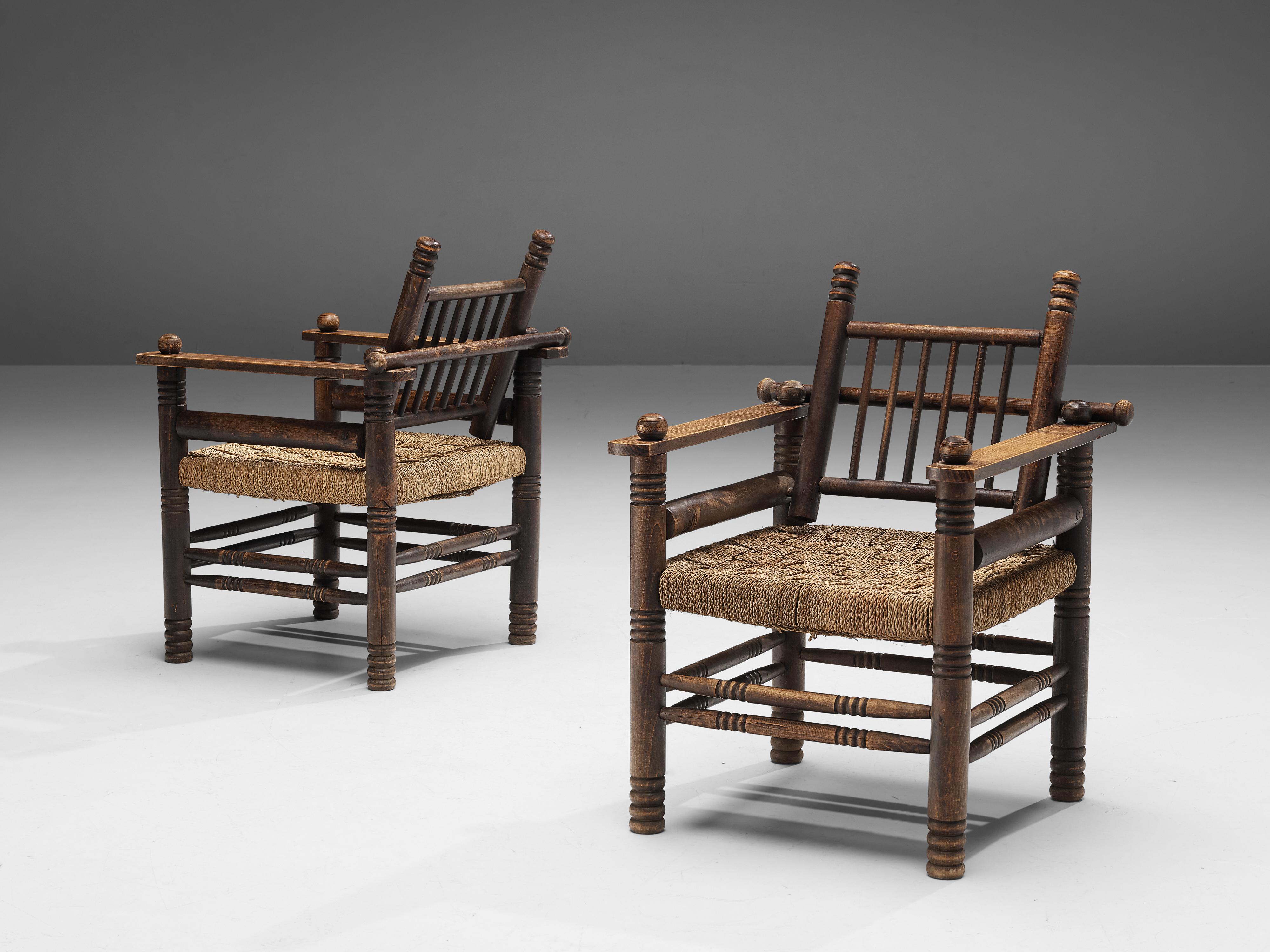 Charles Dudouyt, lounge chairs, oak, papercord, France, 1940s

Decorative lounge chairs by Charles Dudouyt. The frame has multiple carved details that add up to a complex whole. Carved lines and circular ends, straight and round parts come