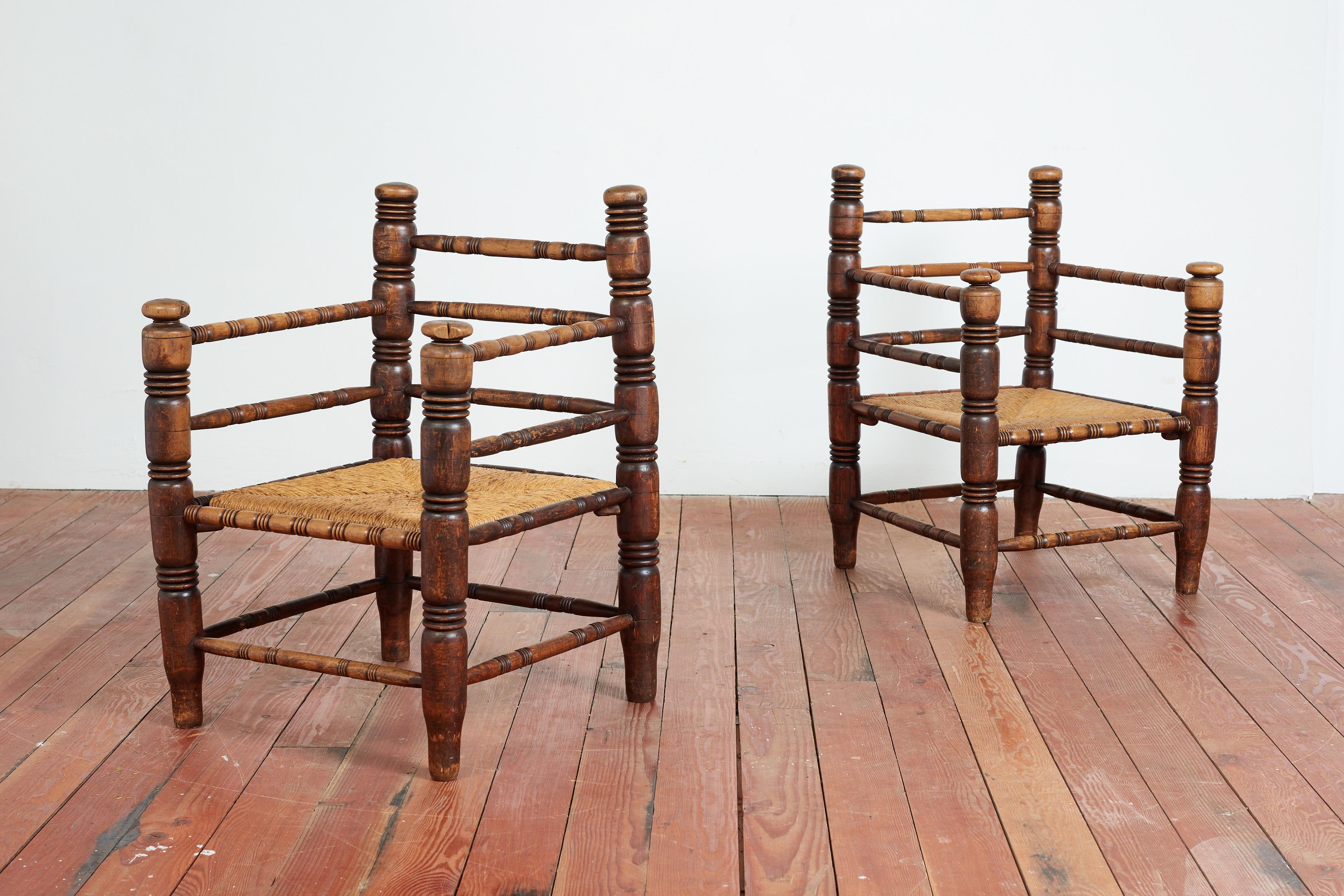 Pair of Charles Dudouyt chairs with rushed seats and signature carved oak frames. 
Wonderful original patina to oak 
France, 1940s