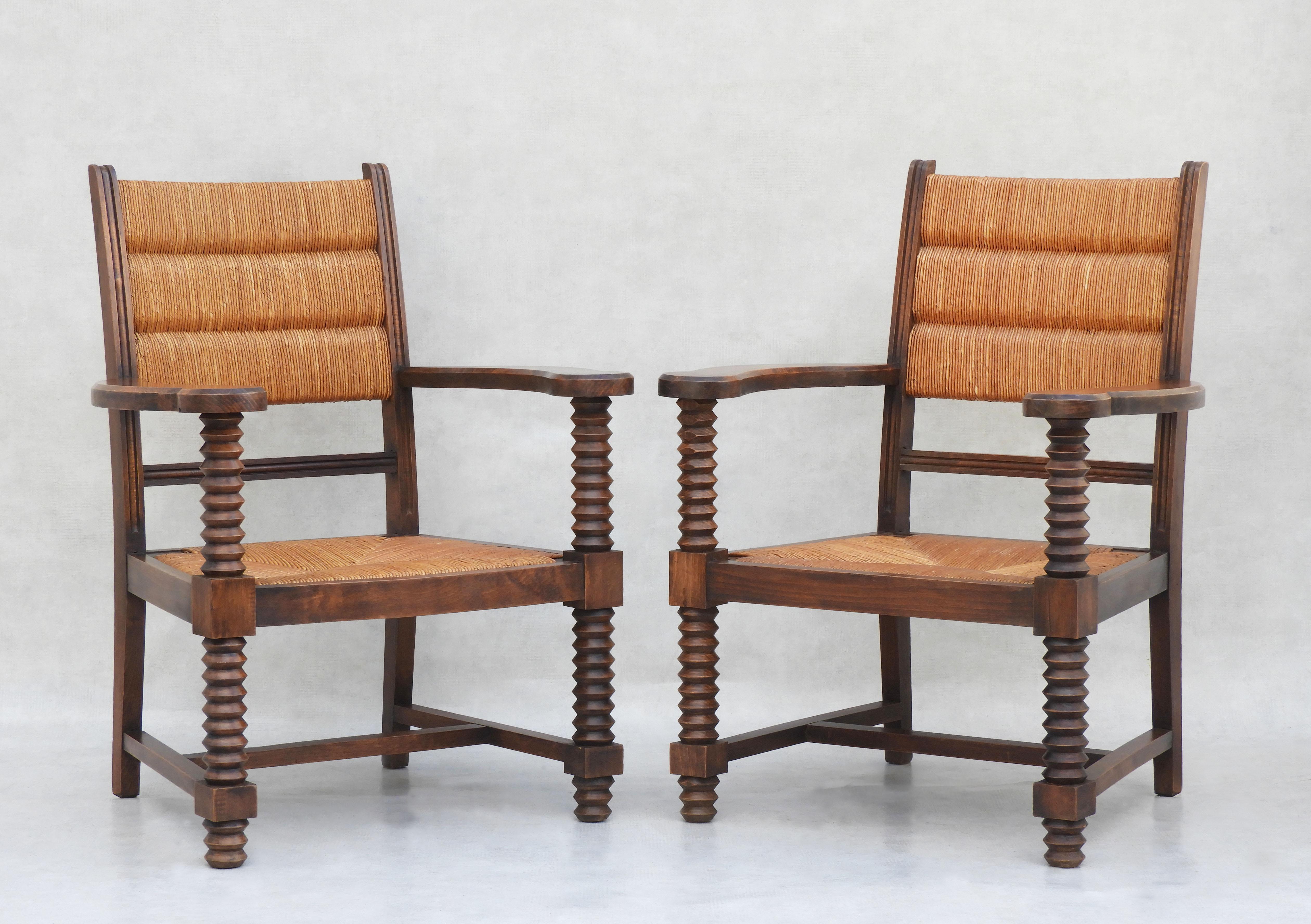 Fabulous Pair of French oak and rush back and Armchairs, by Charles Dudouyt C1940           
Great design and good craftsmanship. All original carved oak frames, signature wine press screw legs, distinctive woven rush work backs and removable seats.