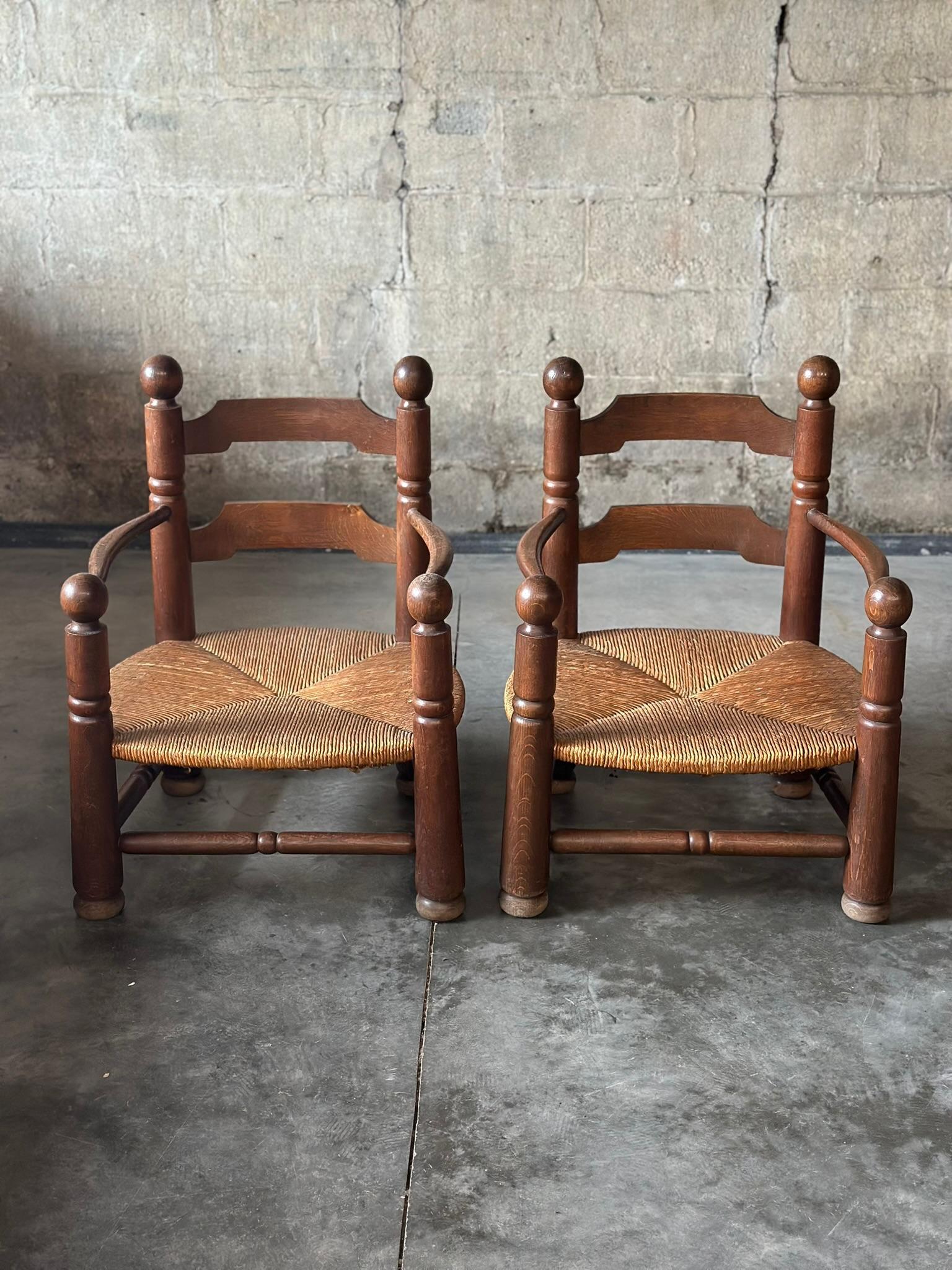 These carved oak armchairs by Charles Dudouyt were originally designed as 