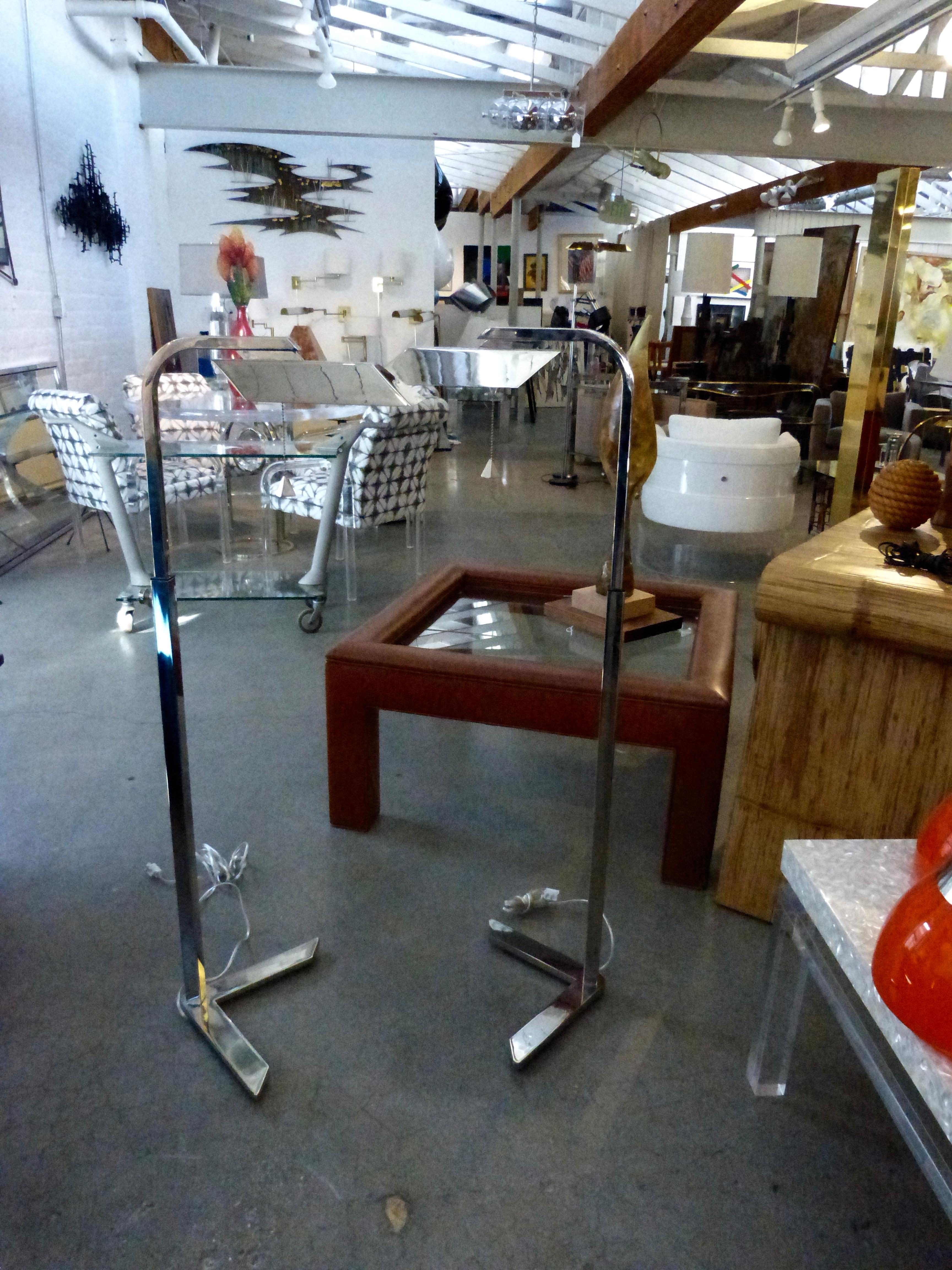 A nice pair of his and her chrome floor lamps by Charles Hollis Jones. They are a matched pair as one is adjustable and the mate is stationary. Working condition. These are quite stunning and have great accent features.
Some slight handling marks