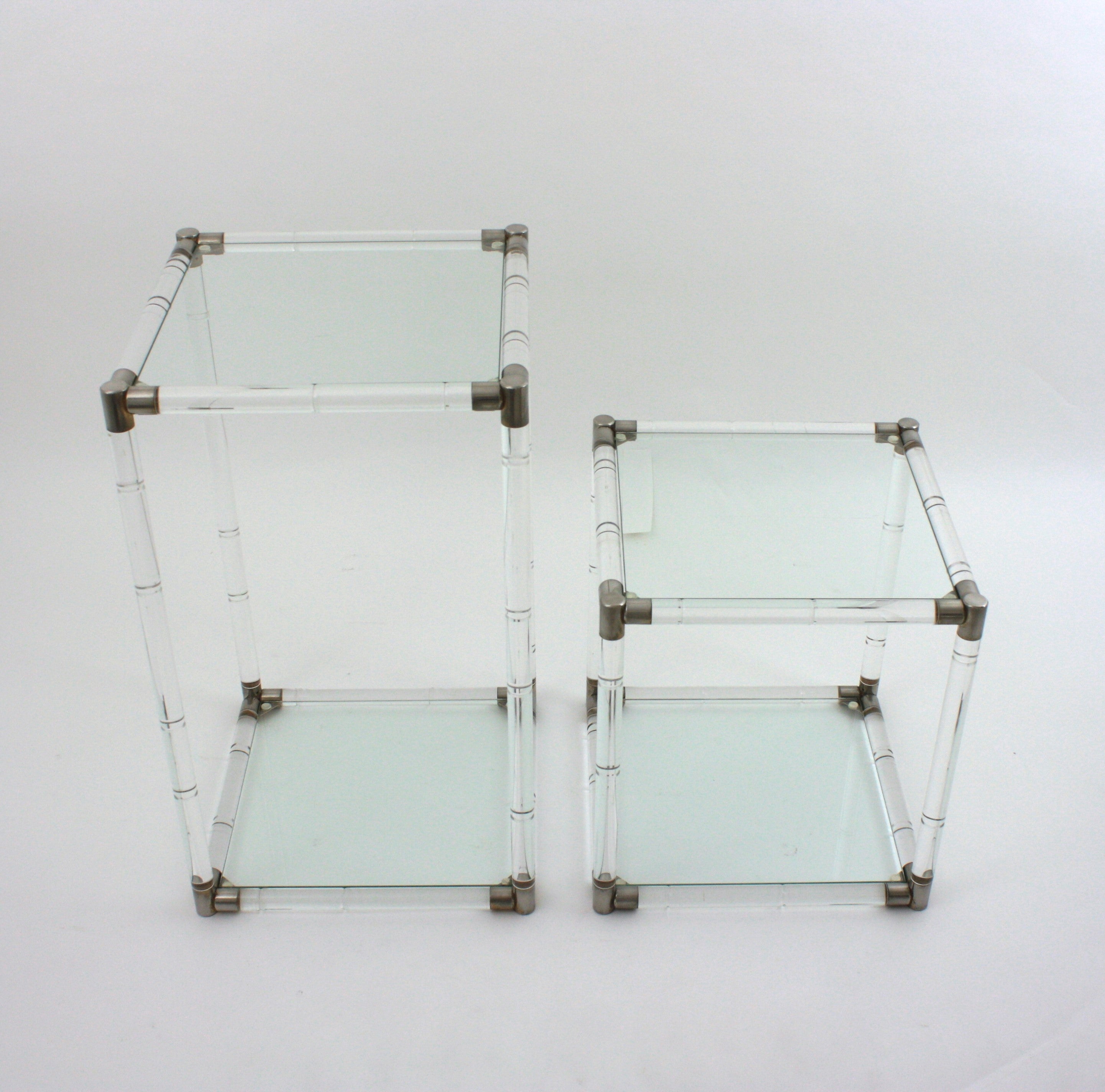 Set of Two Mid-Century Modern lucite side tables with glass top, Spain, 1960-1970.
 Sculptural Midcentury squared side tables with acrylic lucite base, glass top and metal accents. These two-tier side tables are constructed with lucite rods joined