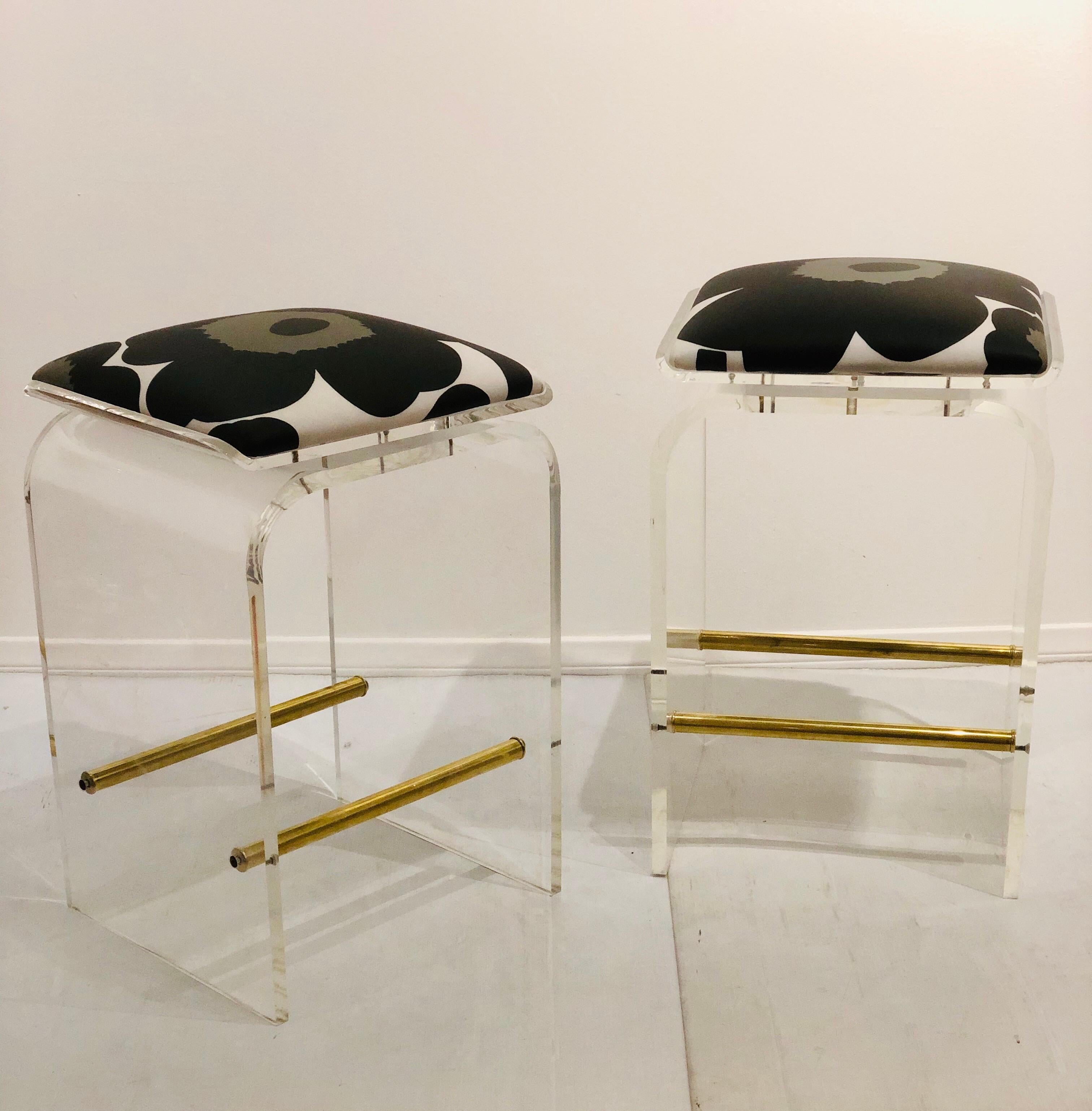 Beautiful pair of Charles Hollis Jones waterfall bar stools in Lucite with swiveling seats, new Maharam Pop upholstery waterproof, new fresh brass polished footrest bars, these pair has been hand polished the seats swivel to 360 degrees, a very nice