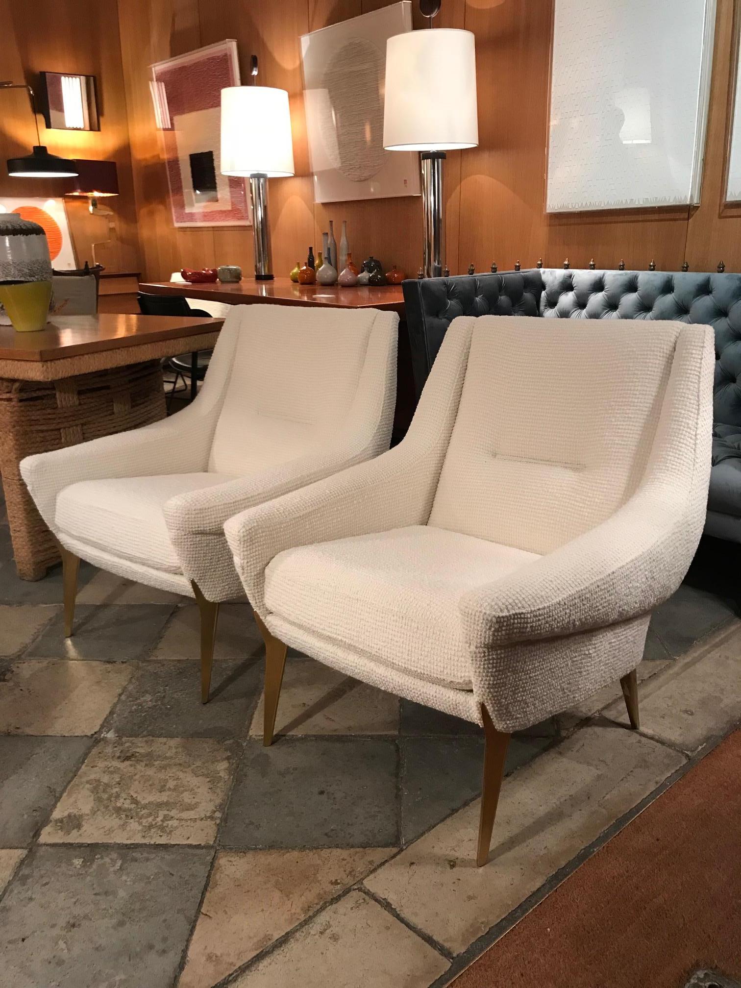 Pair of armchairs with anodized cast aluminium legs designed by Charles Ramos, recently reupholstered with a white Bisson Bruneel fabric.