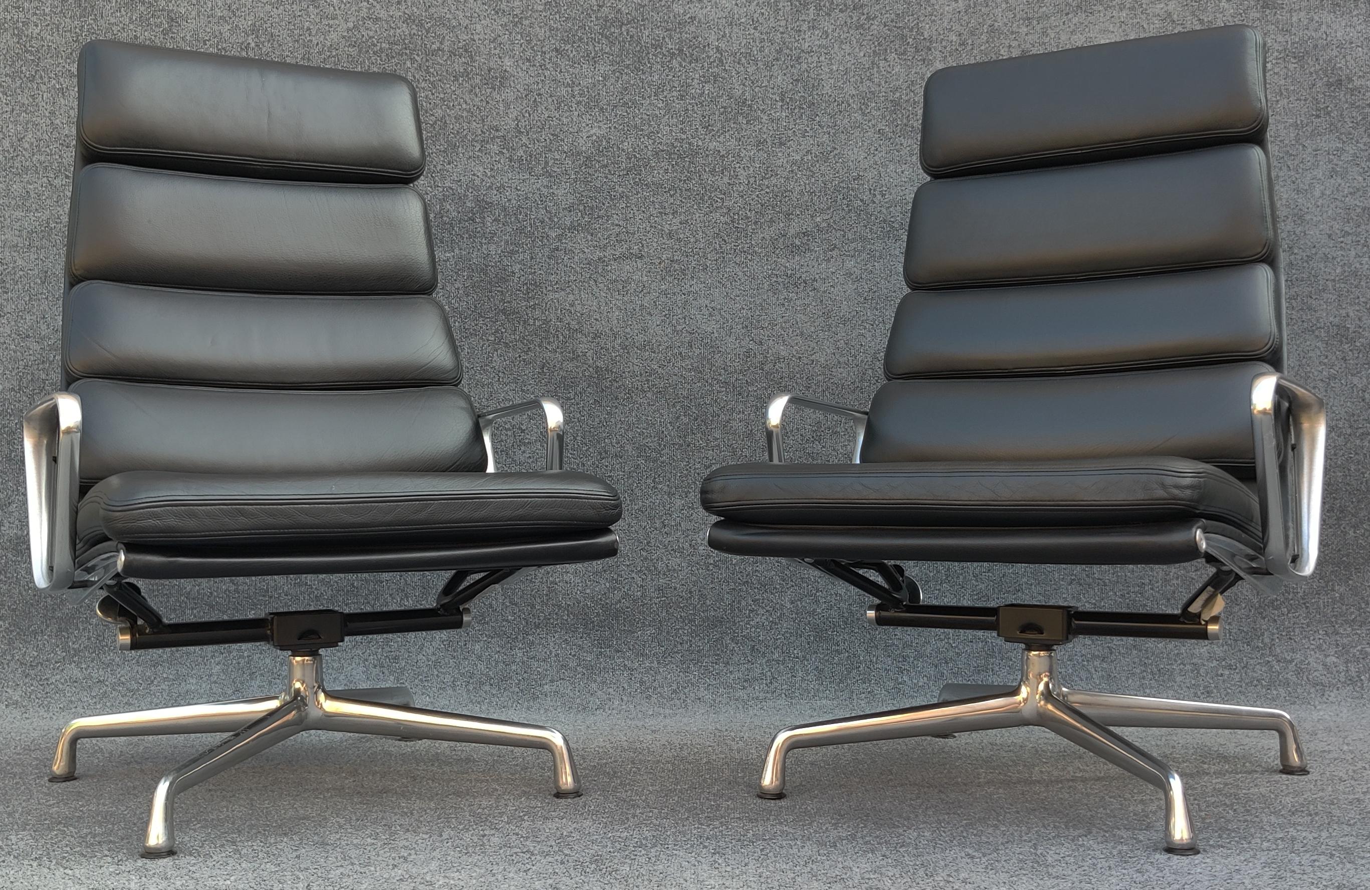 Designed by Charles and Ray Eames in the late 1950s, this pair of black leather lounge chairs is the pinnacle of the Herman Miller Aluminum Group family of seating. This pair is not only of the lounge variety, but also features the iconic 4-prong