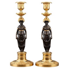 Pair of Charles X Candlesticks in Patinated and Gilded Bronze