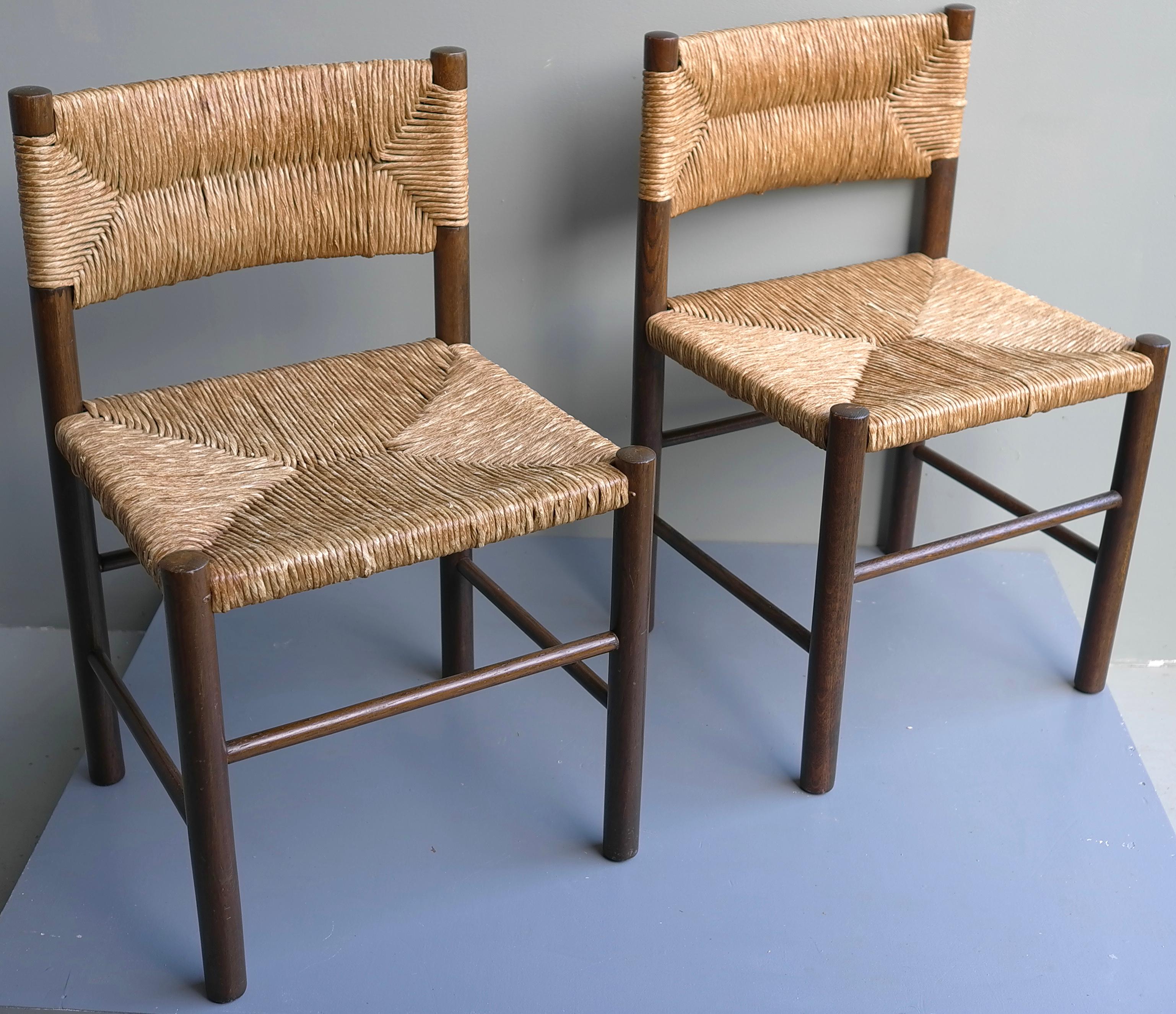 Pair of Charlotte Perriand 'Dordogne' chairs in wood and rush. By Robert Sentou, France, 1960's.