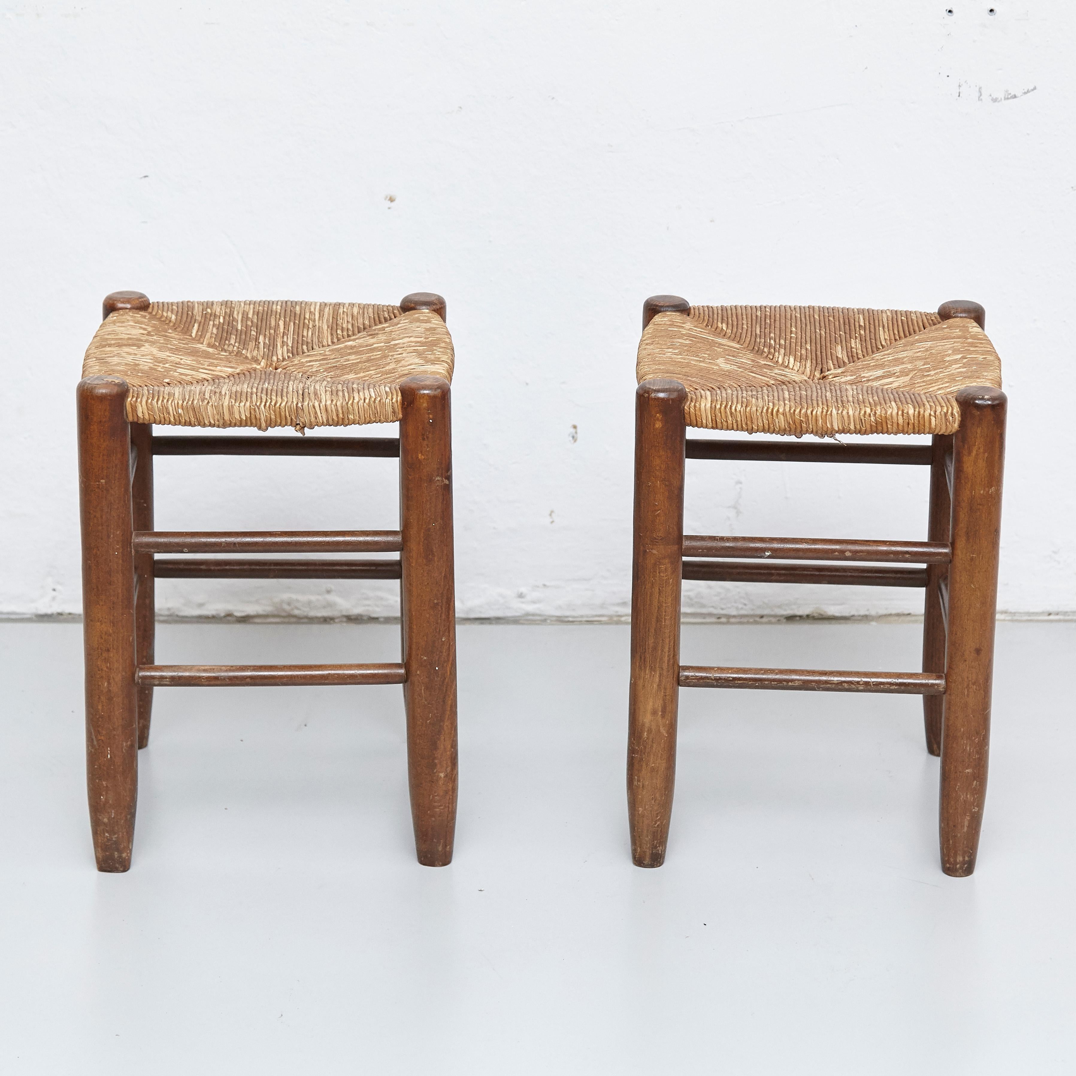 Pair of stools designed by Charlotte Perriand, circa 1950.
Manufactured in France.
Wood and rattan. 

In original condition, with minor wear consistent with age and use, preserving a beautiful patina.

Charlotte Perriand (1903-1999) She was