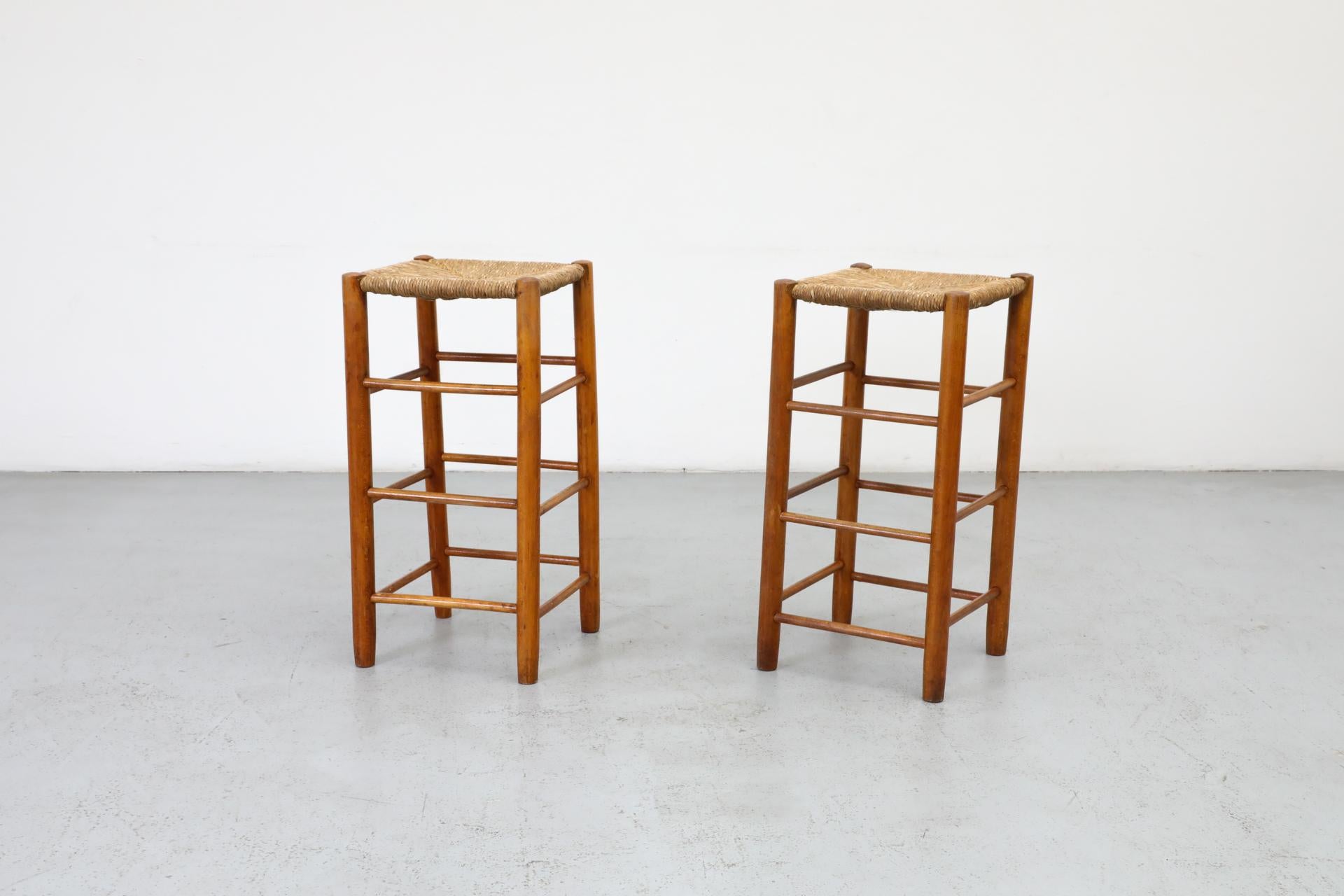 Stained Pair of Charlotte Perriand Style Rattan Counter Stools, 1960's