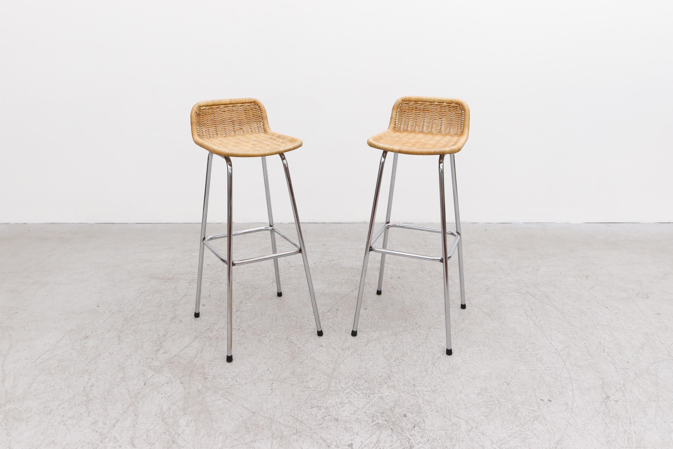 Pair of Charlotte Perriand Style Bar Stools with Low Rounded Rattan Seat Backs and Chrome Tubular Frames. Inspired by  the famous 'Les Arcs' stools by French architect and designer Charlotte Perriand that were designed as part of the acclaimed Arc