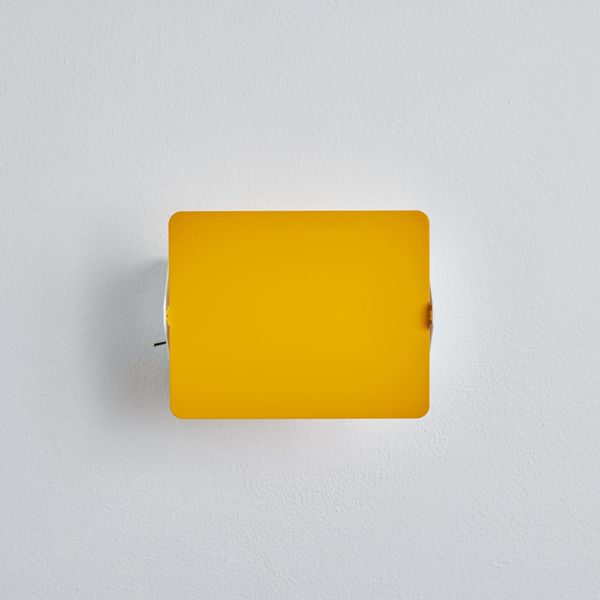 Pair of Charlotte Perriand yellow 'Applique Á Volet Pivotant' wall lights. 

Originally designed in the 1950s as the iconic CP1, these newly produced authorized re-editions are still made in France with the highest level of integrity and attention