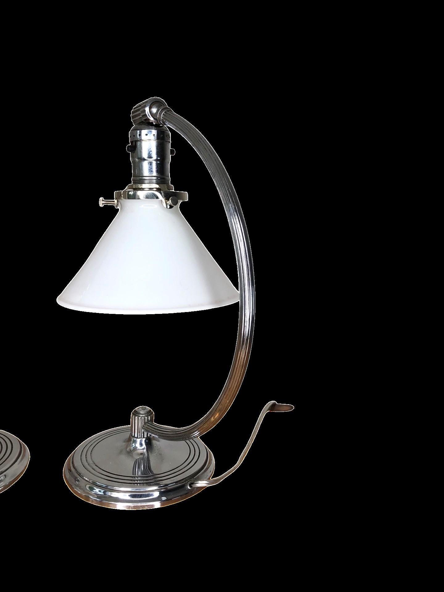 1930’s Chase Lamp Company Chrome Art Deco Desk Lamps, featuring a pivoting head and milk glass lampshades. Stamped on the base with Chase archer mark. Wired and in good working condition
