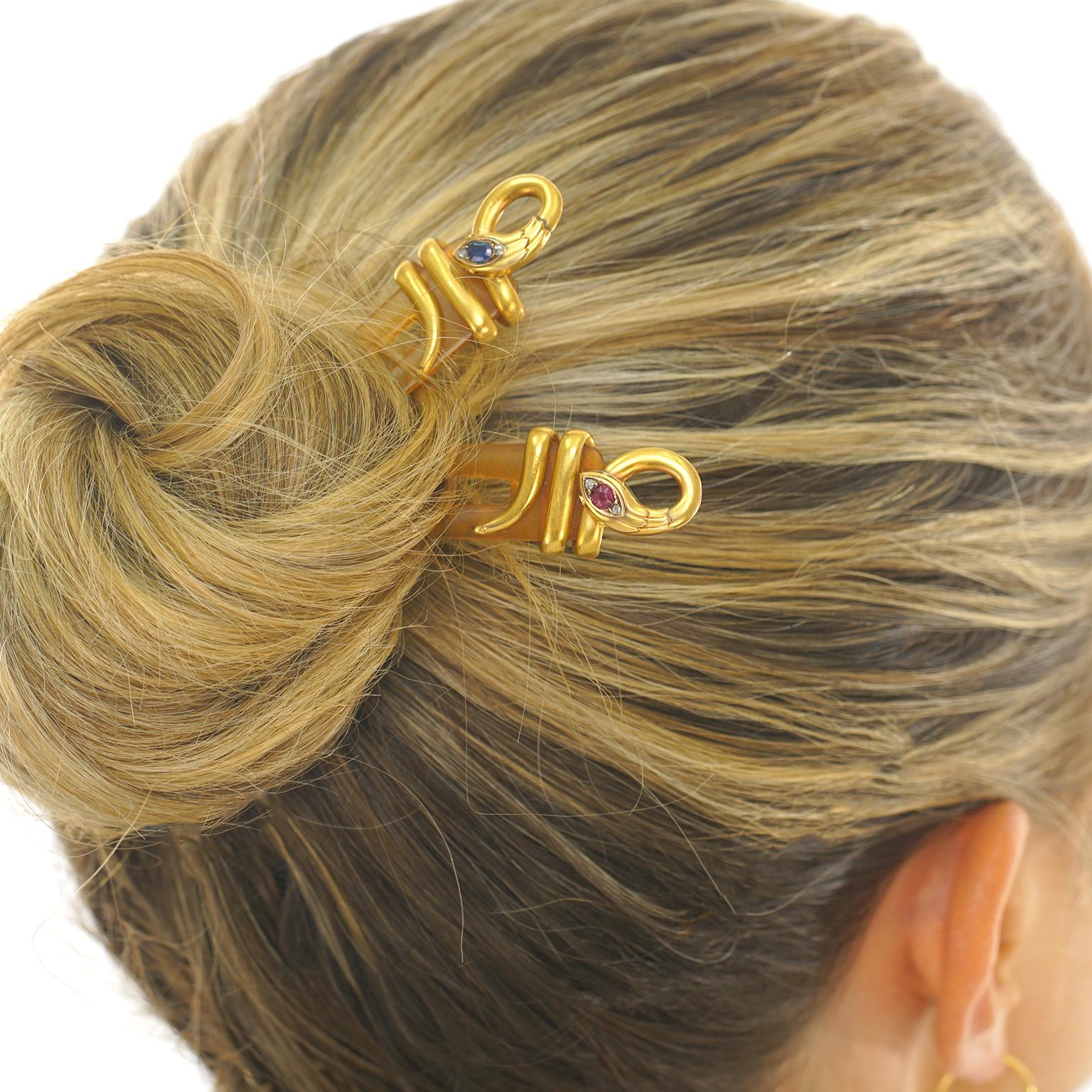 Circa 1890s, 18k, retailed by Chaumet, France.  Ornamented with sapphire and ruby set 18k gold snakes, these hair pins from the renowned house of Chaumet, are one-of-a-kind delights. Retailed by Chaumet in late 19th century, they add mystical,