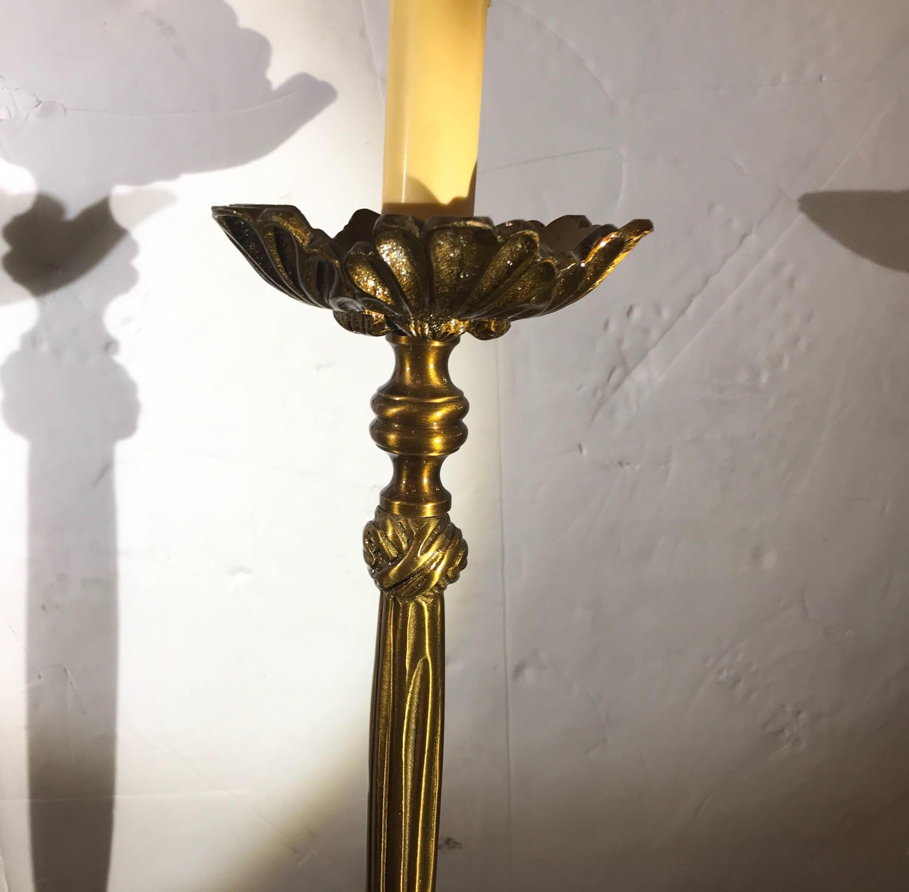 Elegant pair of cast brass tall buffet or console lamps with silk shantung scalloped shades. The finish is an aged gilt bronze. Excellent condition with clean safe wiring made for Chelsea House. The lamps with shades are 32 inches tall, the lamps to