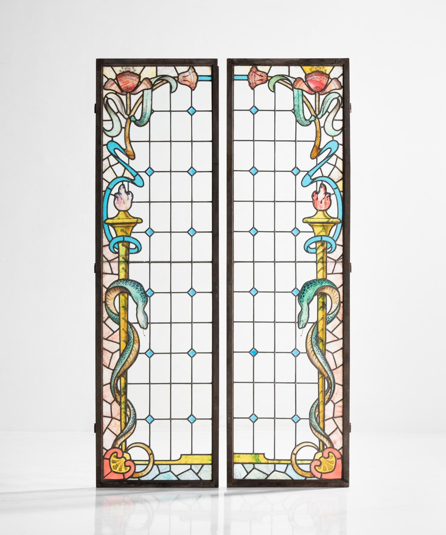Pair of chemist shop shutters, England, circa 1910.

Simple geometric patterning with elegant border motif on iron-supported glass panes in original wood shutters.