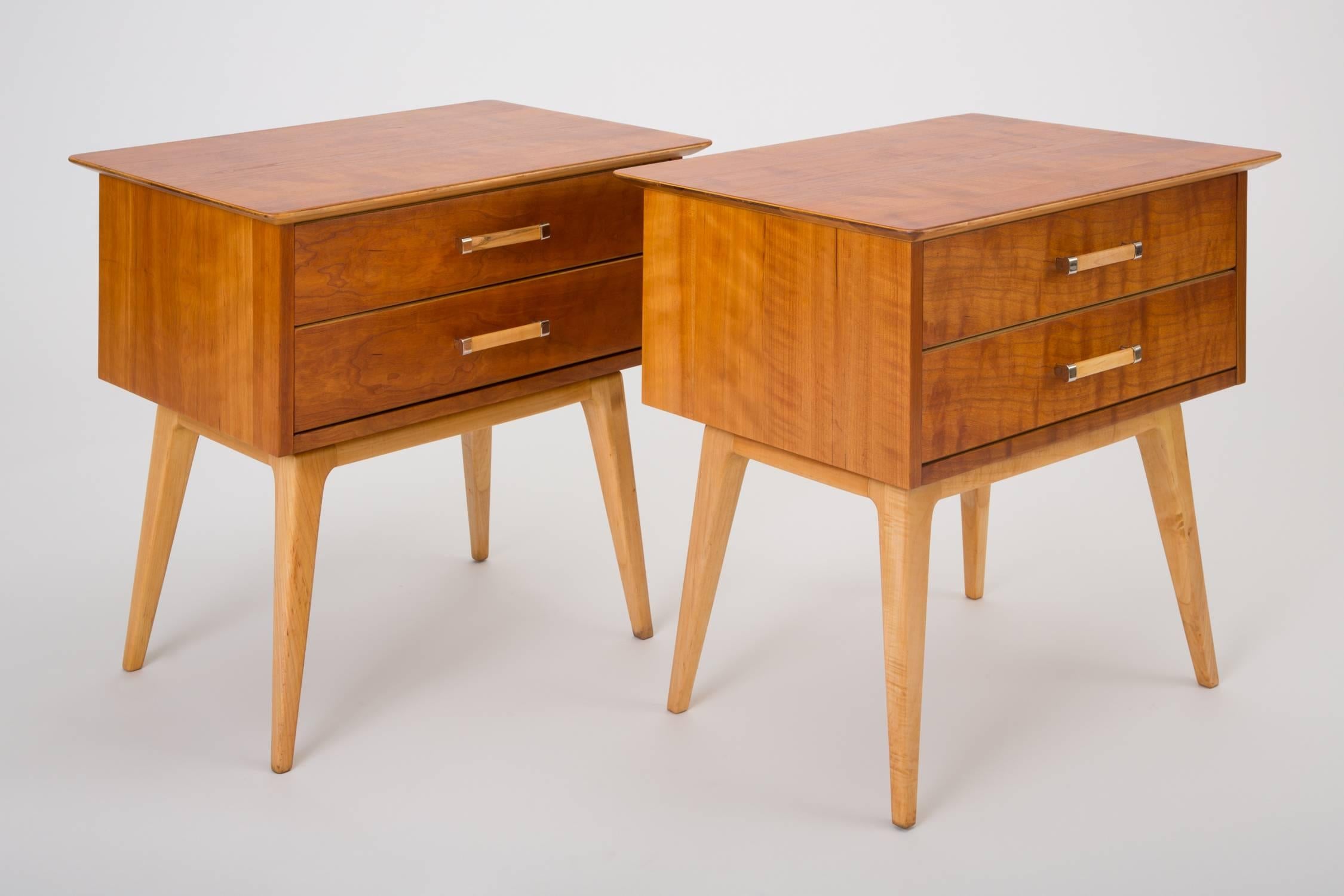 A stately pair of modern nightstands in subtly figured curly cherrywood with contrasting birch accents and brass fittings. Designed in the early 1950s for Johnson Furniture by longstanding creative director Renzo Rutili, and retailed by John Stuart