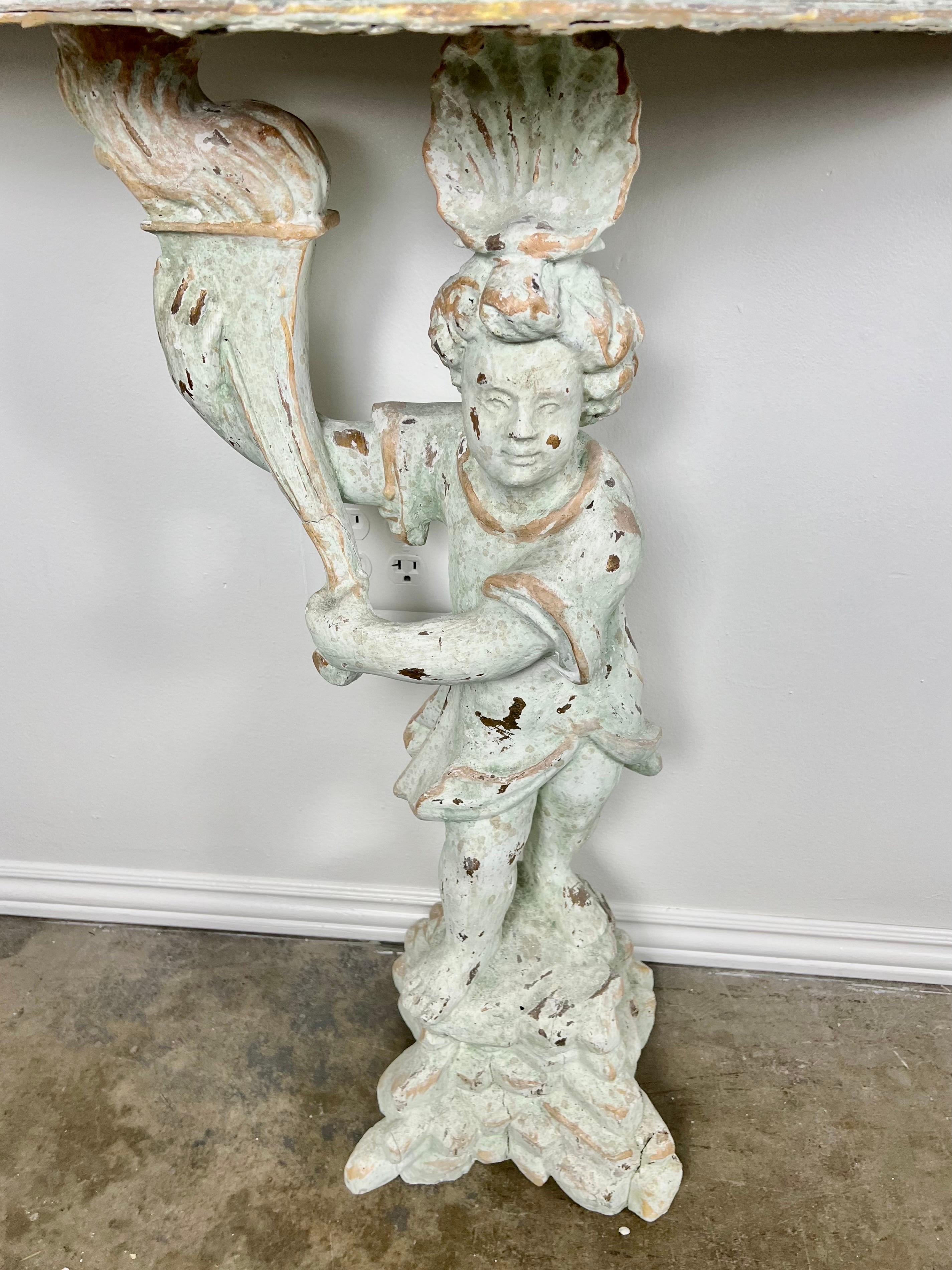 Pair of Cherub Consoles with Marble Tops, circa 1930s In Distressed Condition For Sale In Los Angeles, CA