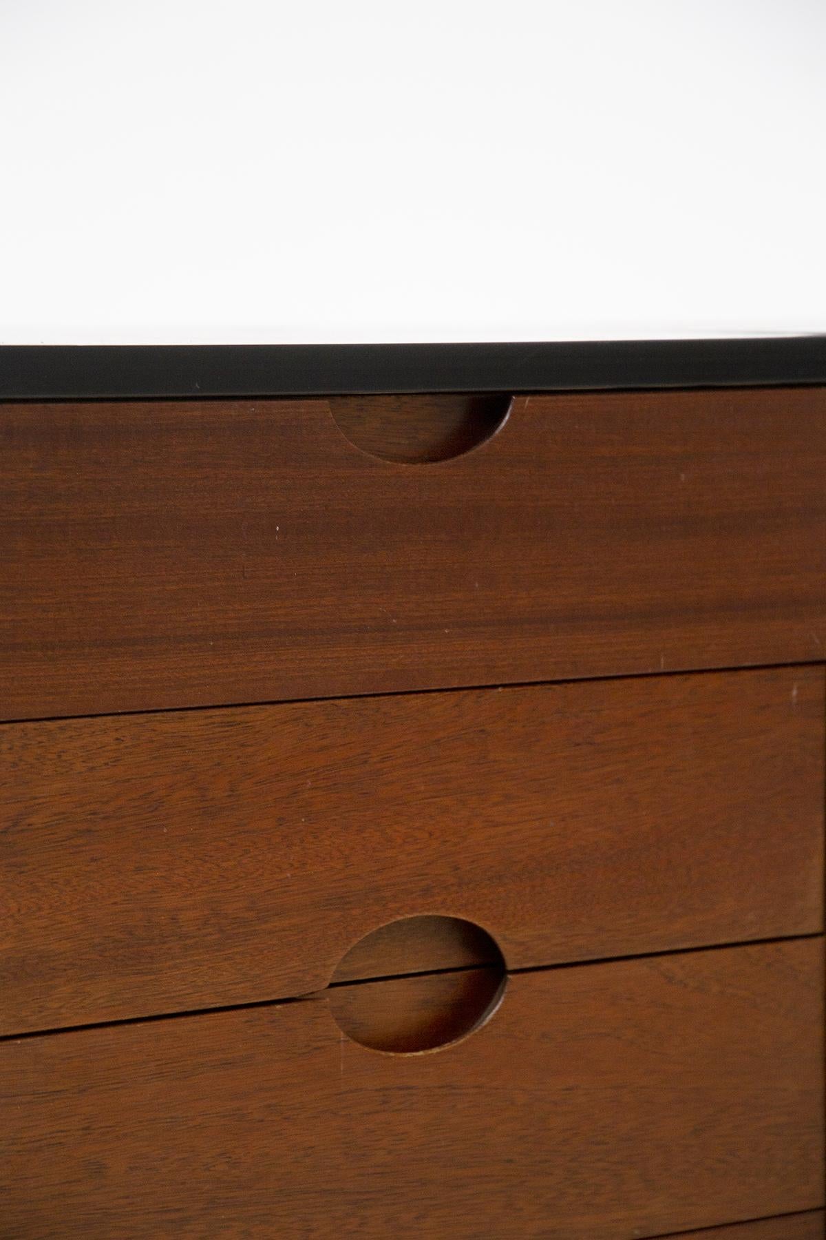 Beautiful pair of wooden chest of drawers made by Luigi Caccia Dominioni in the 70's for the Vips Residence.
The chests of drawers are made of wood in lighter and darker shades of brown.
The structure is rectangular, each consisting of 5 drawers and