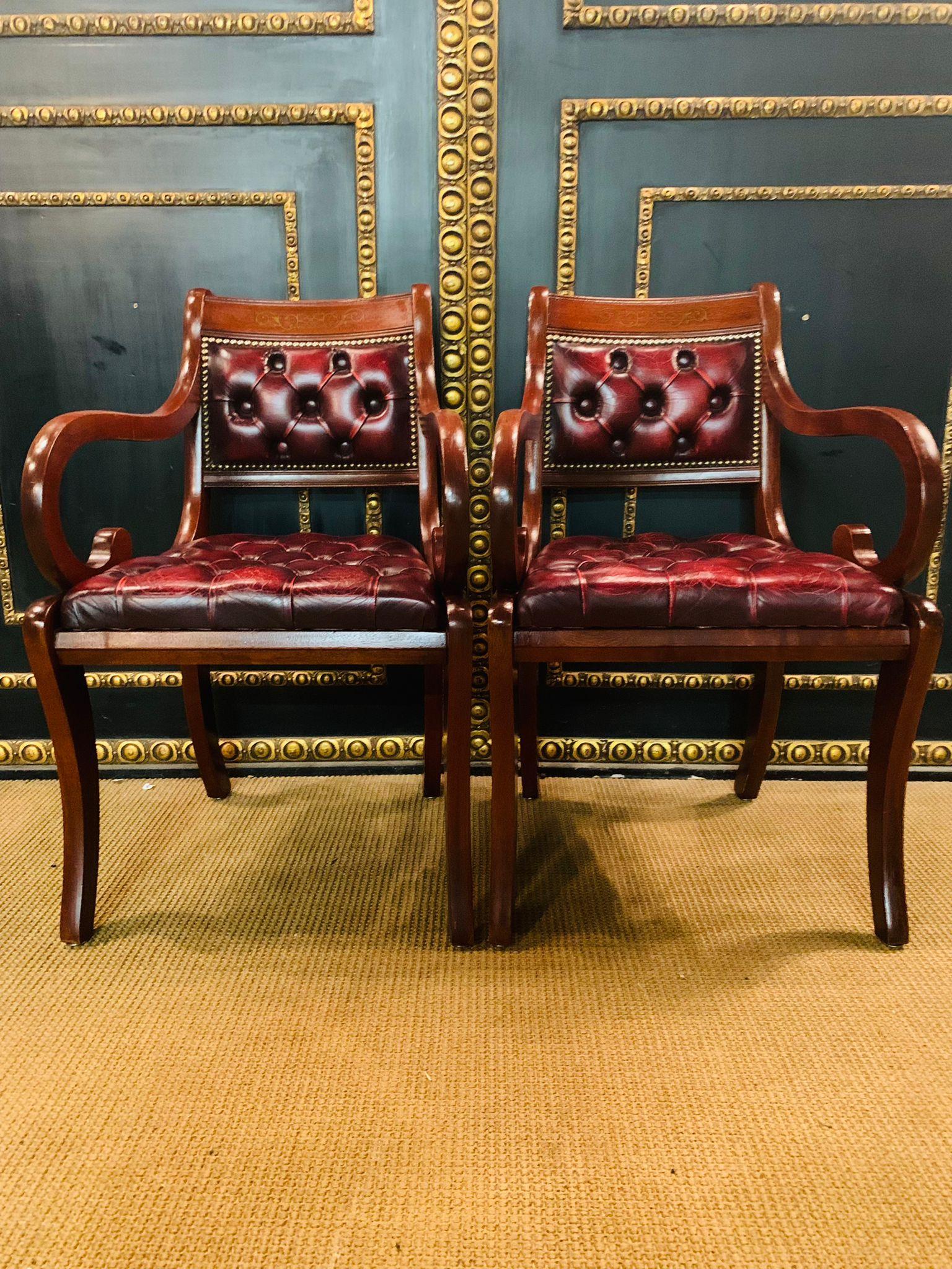 We are delighted to offer you this stunning pair of Chesterfield carver armchairs in oxblood leather with hand carved frames. The chairs are a lovely find and in original condition throughout, both are buttoned and look glorious from every angle