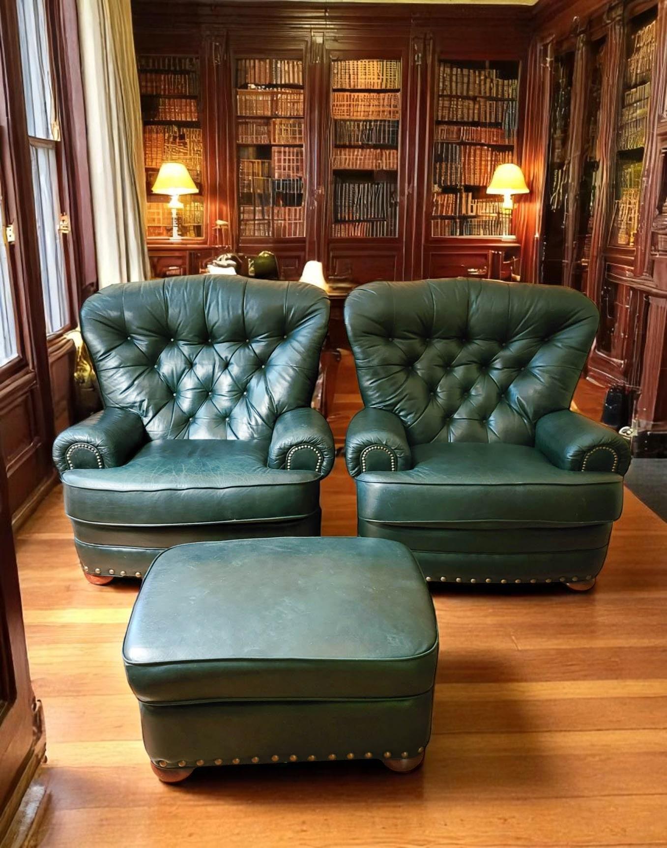 Indulge in ultimate comfort with this handsome set of two substantial club chairs and a matching ottoman. Upholstered in rich, dark green leather with deep button tufting, rolled arms accented by nailhead trim, and plush cushions, these