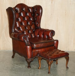 PAIR OF CHESTERFIELD VINTAGE OXBLOOD LEATHER WINGBACK ARMCHAIRS & FOOTSTOOLs