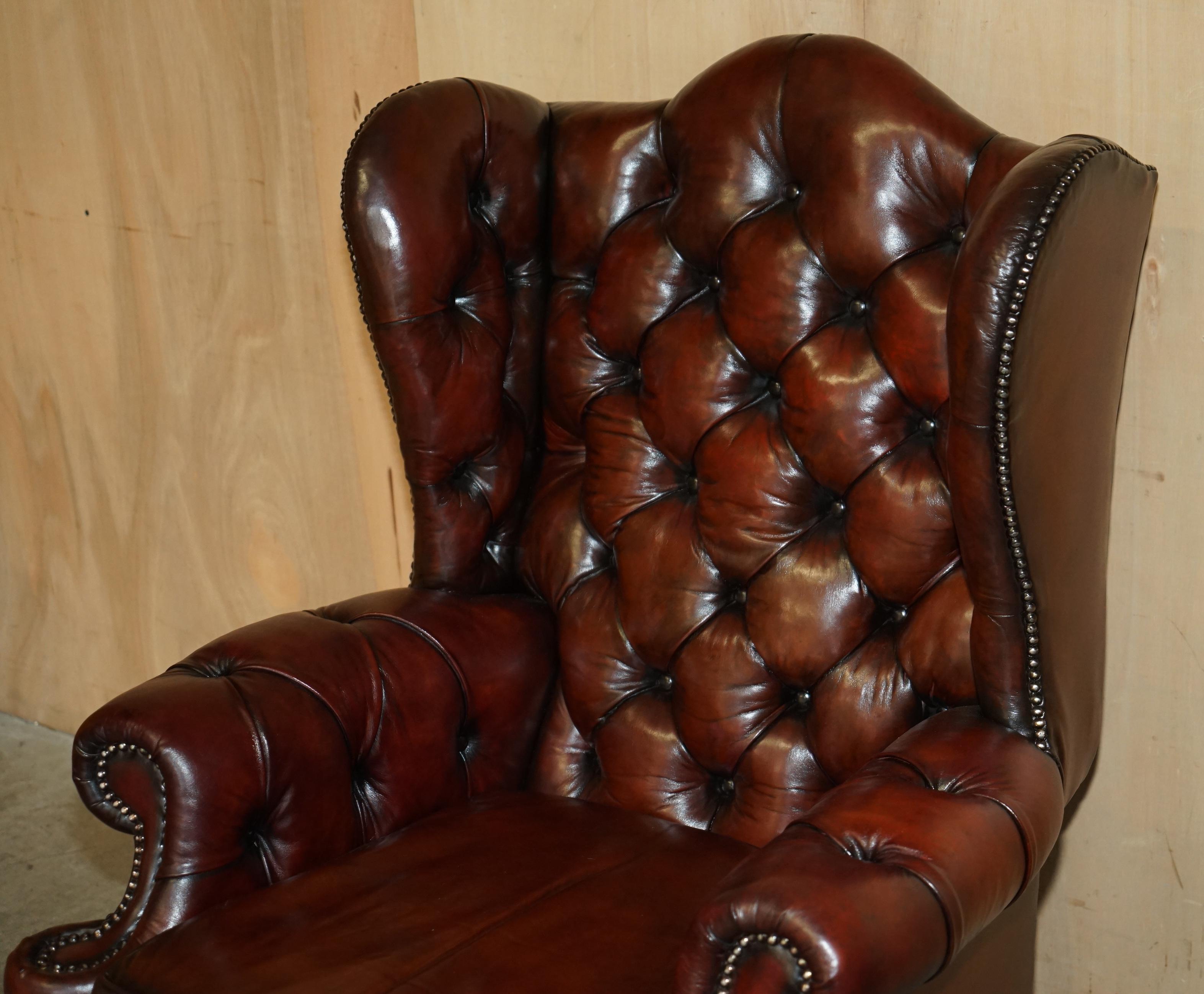 English PAIR OF CHESTERFIELD VINTAGE OXBLOOD LEATHER WINGBACK ARMCHAIRS & FOOTSTOOLs For Sale