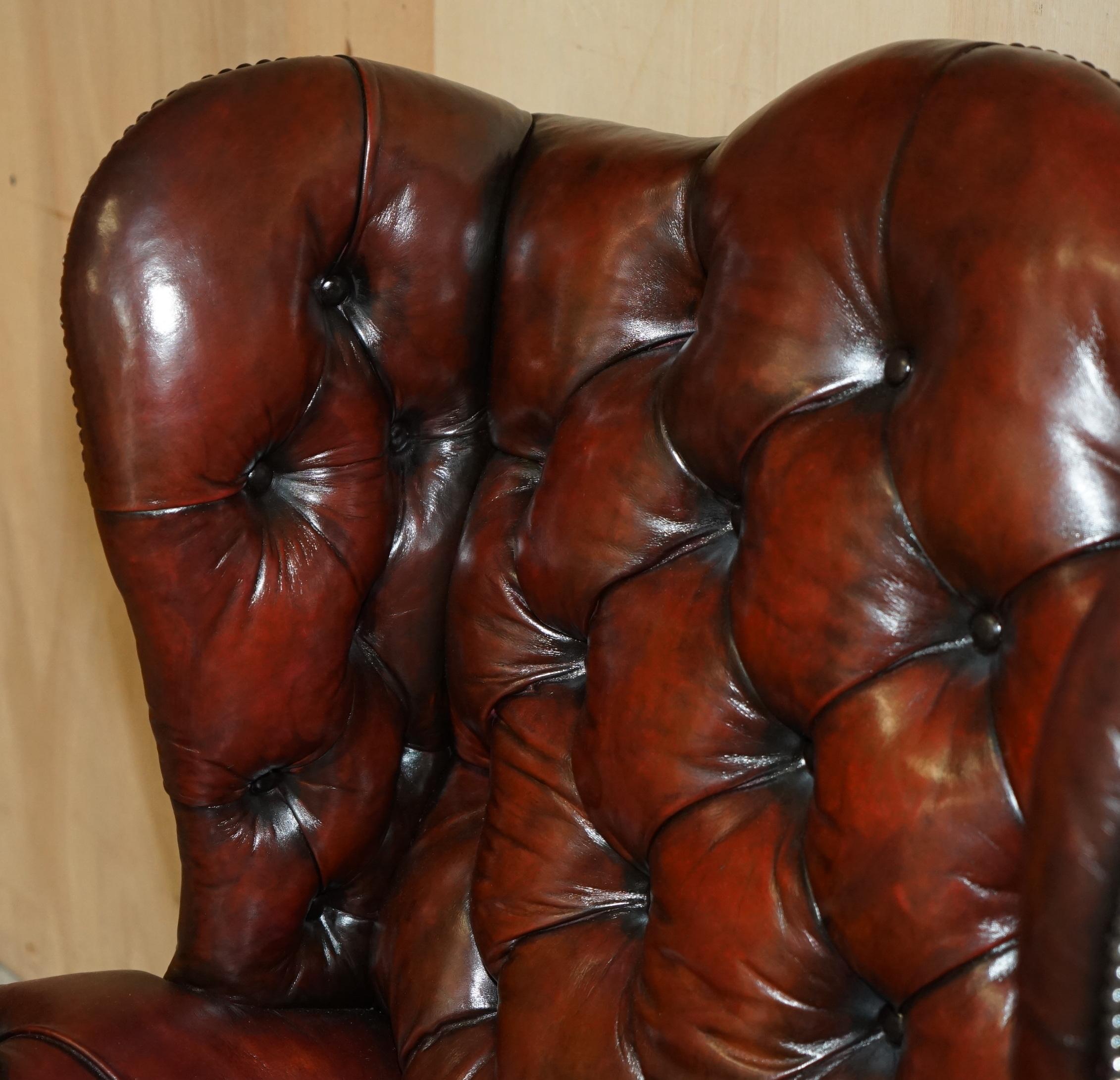 PAIR OF CHESTERFIELD VINTAGE OXBLOOD LEATHER WINGBACK ARMCHAIRS & FOOTSTOOLs In Good Condition For Sale In West Sussex, Pulborough