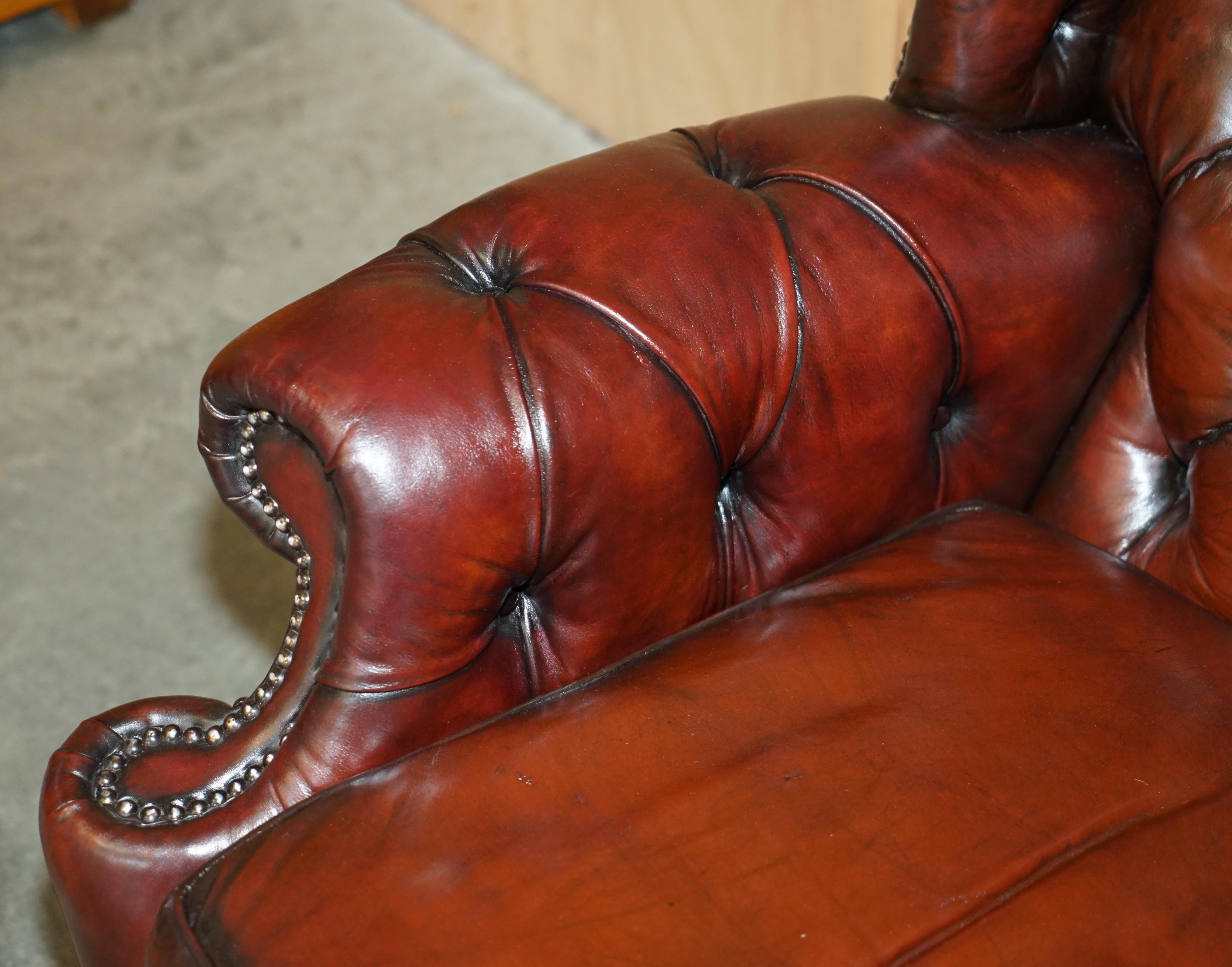 Leather PAIR OF CHESTERFIELD VINTAGE OXBLOOD LEATHER WINGBACK ARMCHAIRS & FOOTSTOOLs For Sale