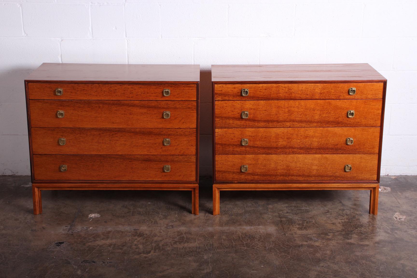 A pair of ash cabinets with oak drawers, rosewood trim and brass hardware. Designed by Edward Wormley for Dunbar.